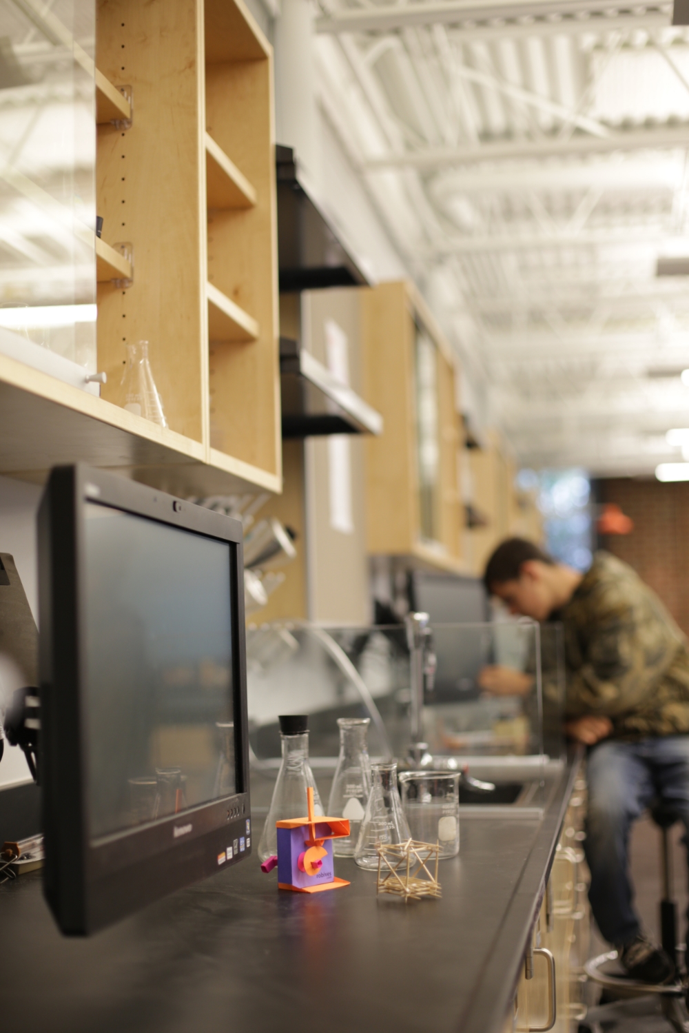 Each lab station features a die-cutter, a 3D printer with direct exhaust, and an arm-mounted video monitor.