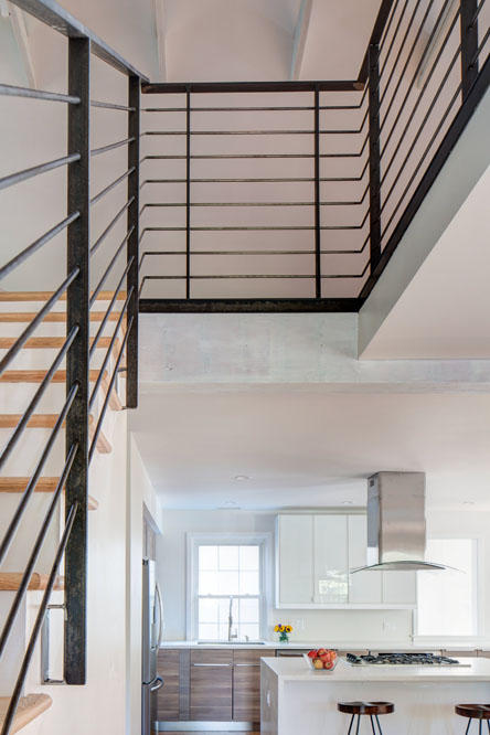 The open stair connects the main floor living area to the loft.