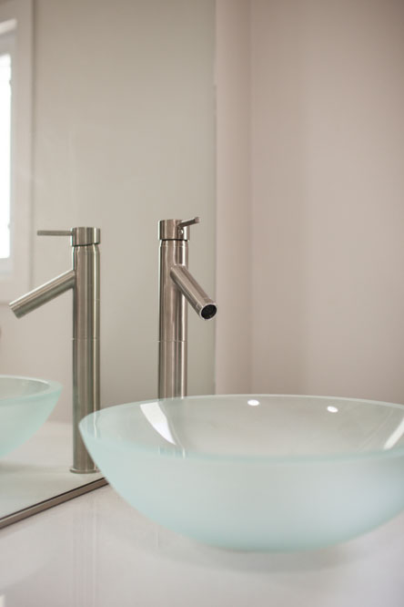 The master bath features a glass vessel sink.