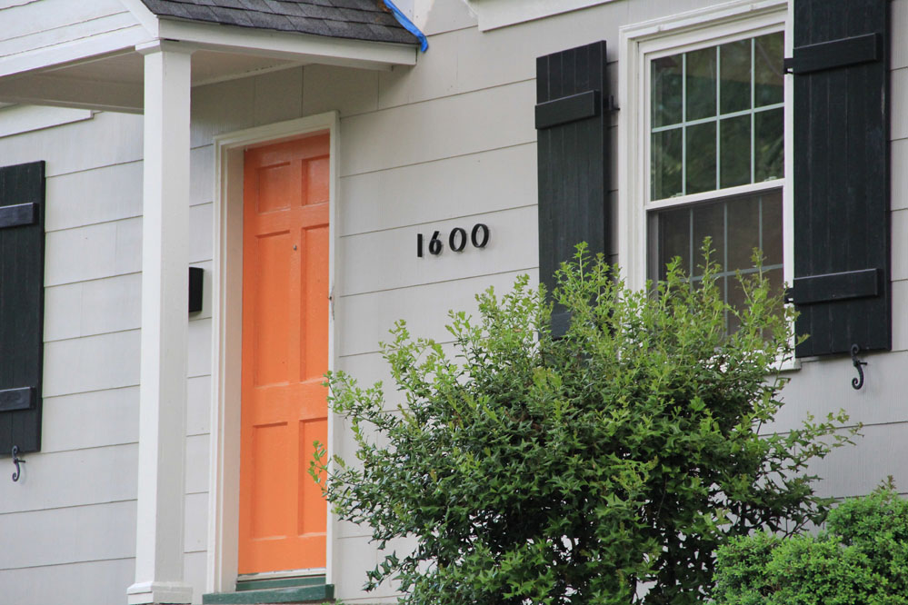 Custom wood shutters and shutter dogs add authenticity to the exterior.