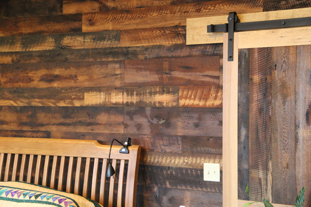 Reclaimed Granary Oak and Hickory create a unique barn door leading to the master bedroom and walk-in closets.