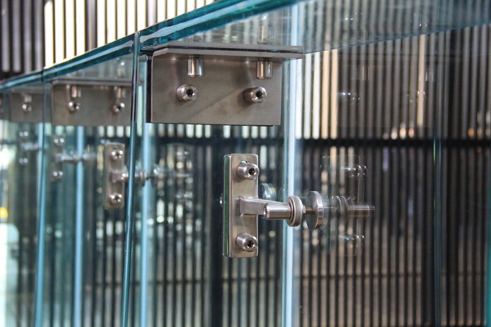 A structural glass wall provides a transparent, but secure separation between the public lobby and the team areas.