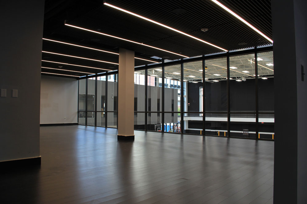 The team lounges, featuring rapidly renewable and low-emitting bamboo flooring, overlook their respective practice courts.