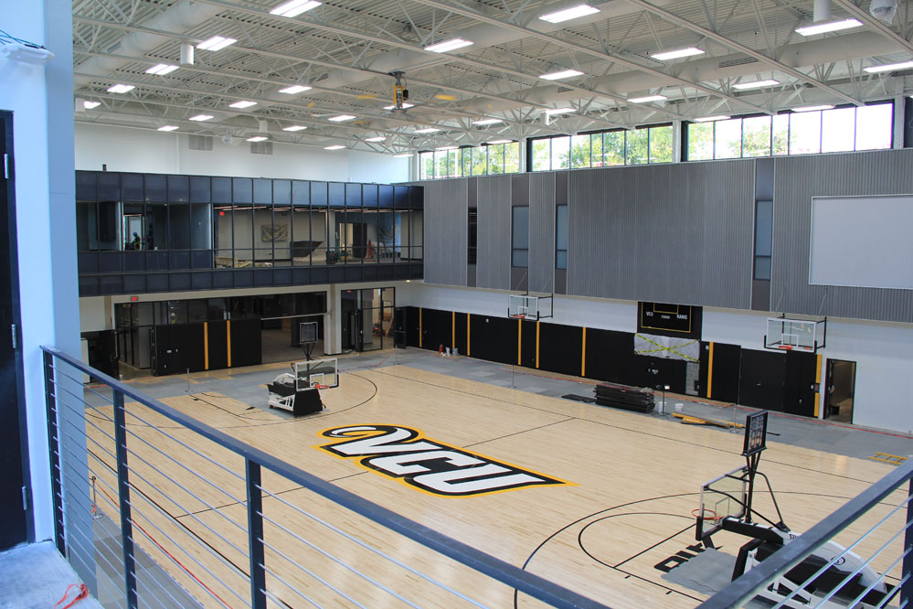 Locker rooms, lounges & offices enjoy views to practice gyms below. Acoustical metal roof deck & wall panels ensure speech intelligibility in the gyms. Gym floors feature FSC-certified maple flooring