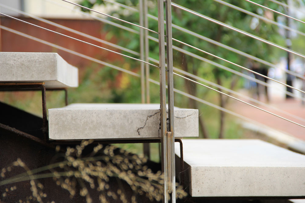 The carefully detailed stair is composed of precast conrete and stainless steel.