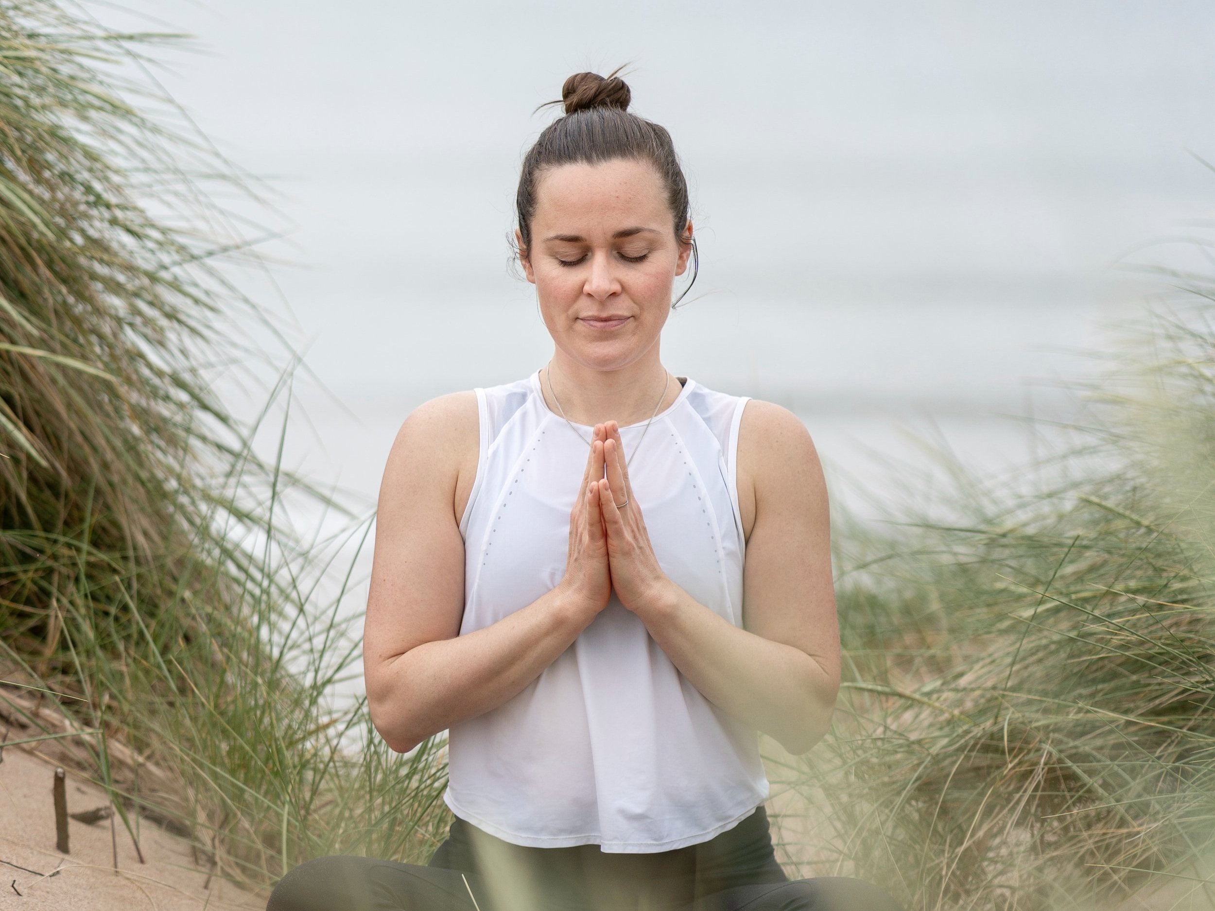 yoga teacher Fern Ross demonstrating yoga pose in East Lothian forest