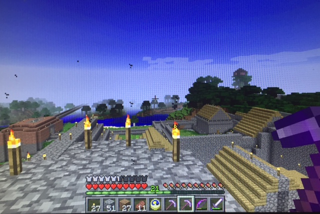 Everything the light touches... the view of some of my castle farm in Minecraft. To the left, a train station. to the right is where I keep the farm animals. 
