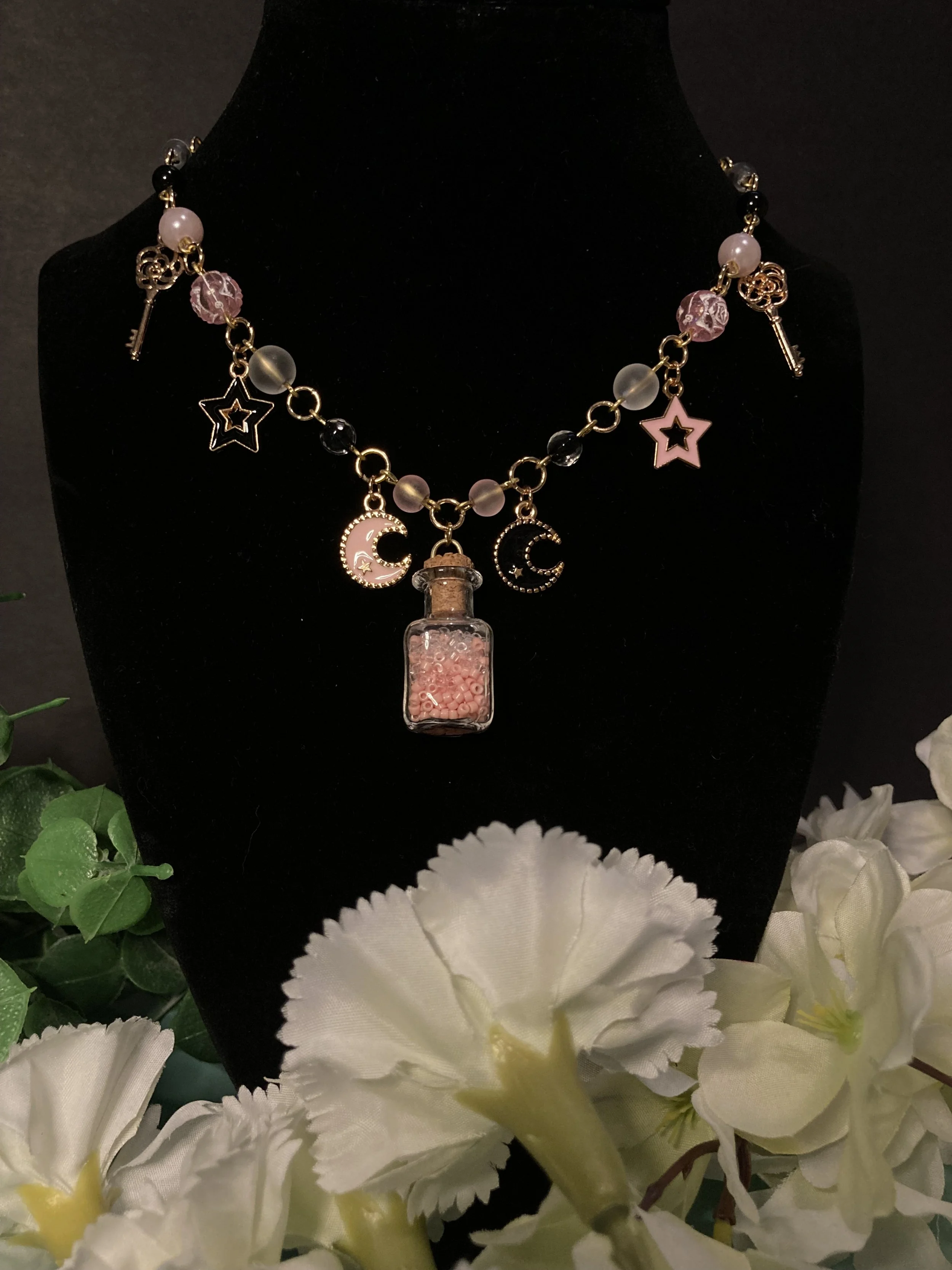 pink and black necklace w bottle.jpg
