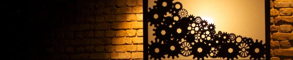 shadows-puppet-cogs-infront-brick-wall.jpg