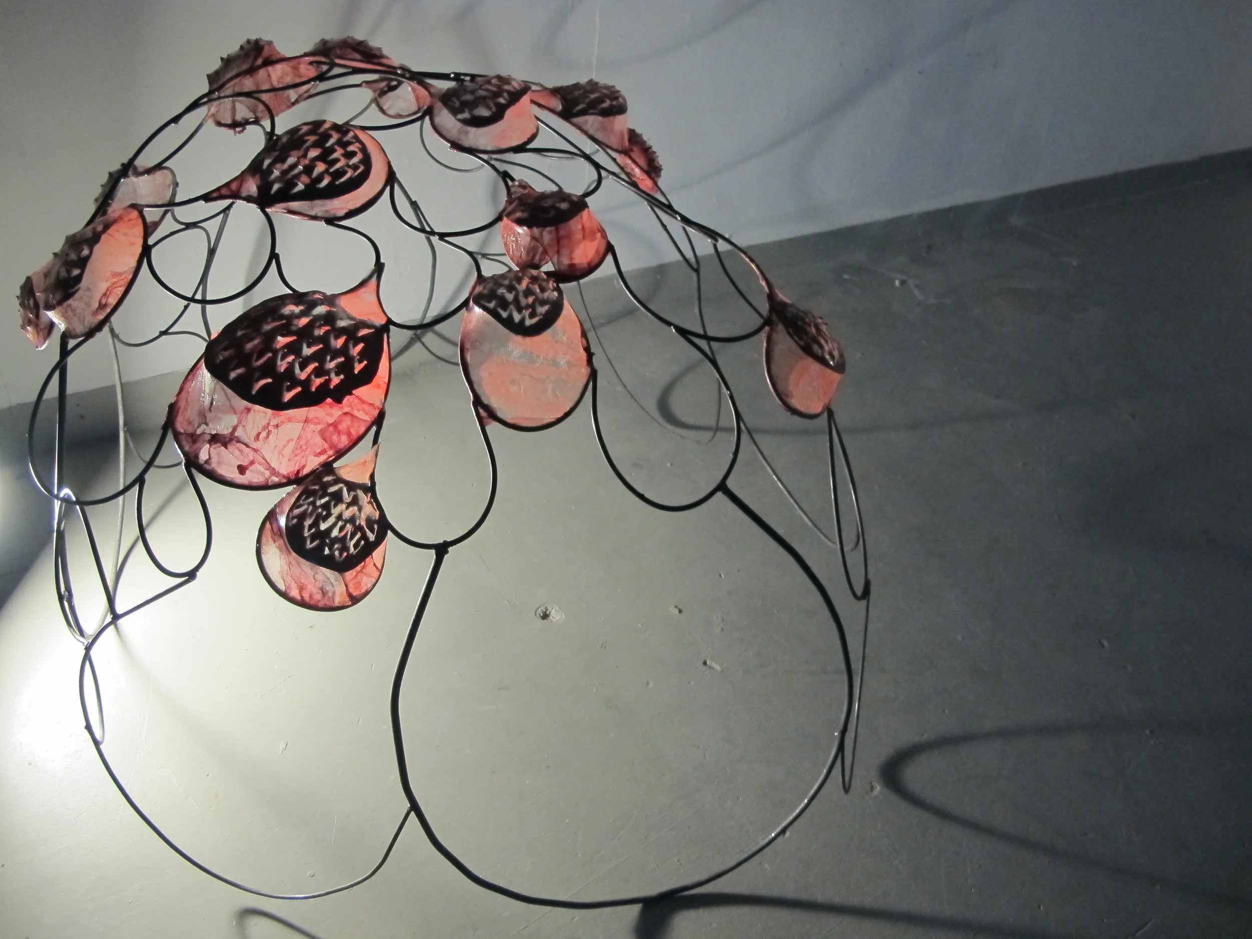 Welded iron and plasma-cut sculpture with pig intestine membrane.