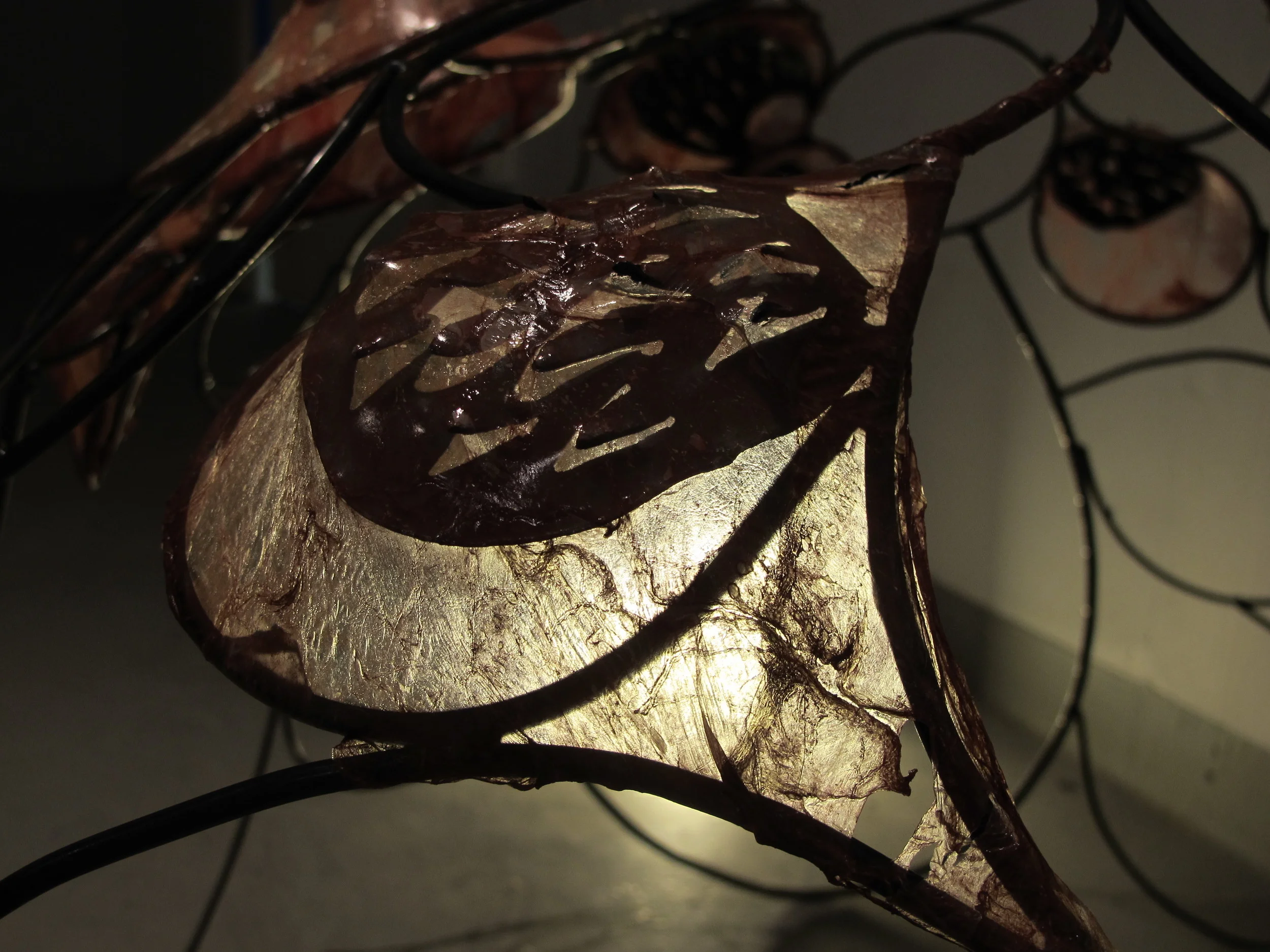 Welded iron and plasma-cut sculpture with pig intestine membrane.