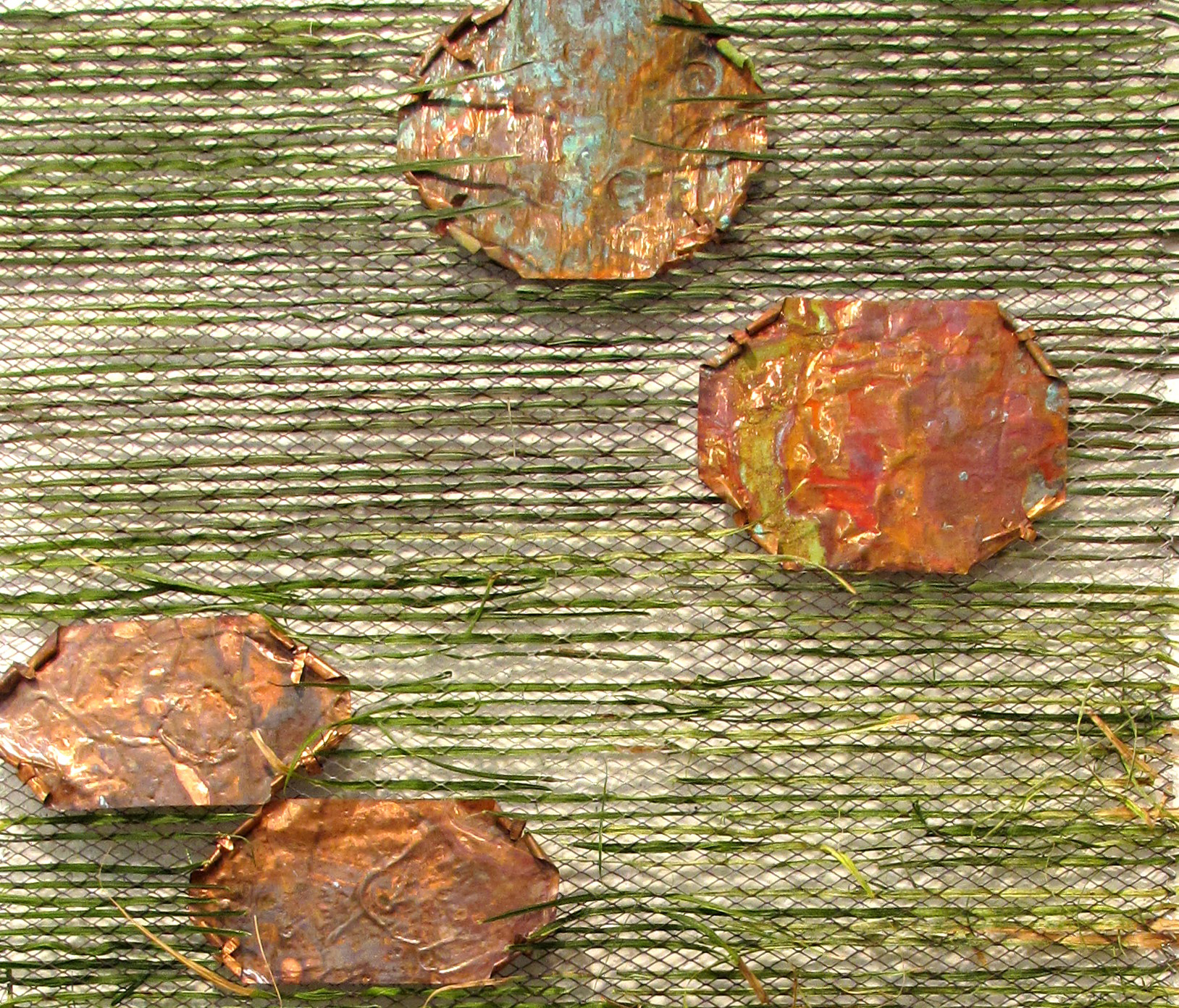 Metal screen with copper plates and palm fronds. 