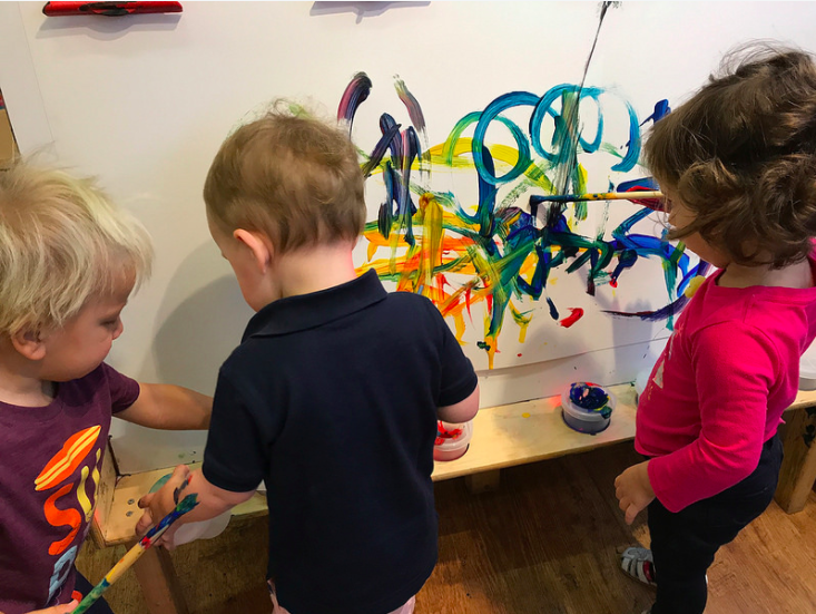  Our friends working alongside one another at the easel! Easel activities promote language development as the children are standing side by side one another. They can work togehter, comment on each other's work as their language progresses, and it bu