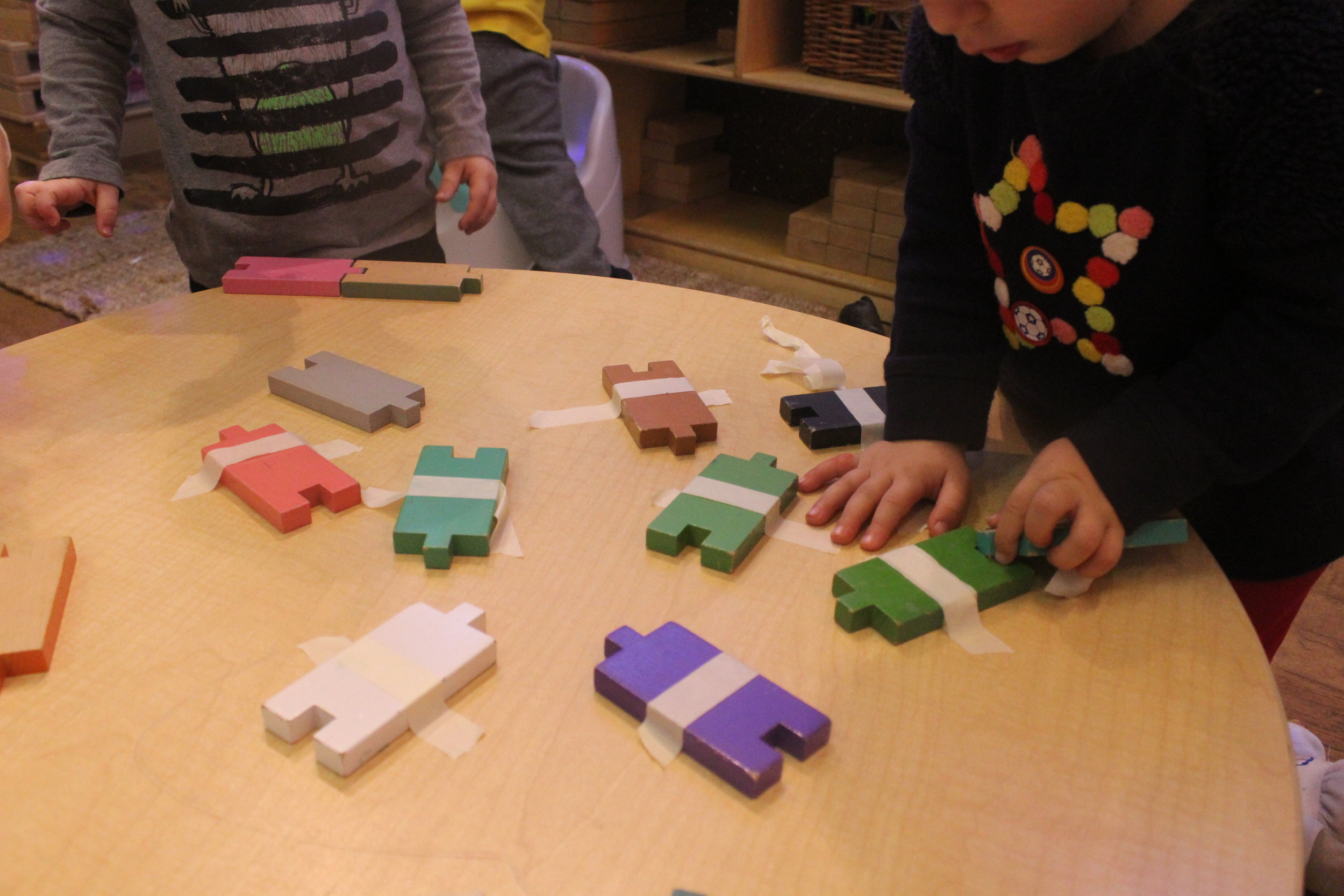  Exploring puzzles - puzzles are a wonderful mathematical tool in spatial awareness, problem solving, and trial and error thinking. The tape is an added support in helping are little learners work on their fine motor skills - much needed for pre-lite