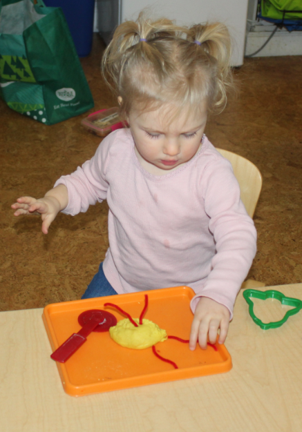  Play dough is a sensory exploration activity.&nbsp; Madeline squeezed and pressed and formed a ball.&nbsp; The teacher provided tools for further exploration and pipe cleaners for adornment.&nbsp; 