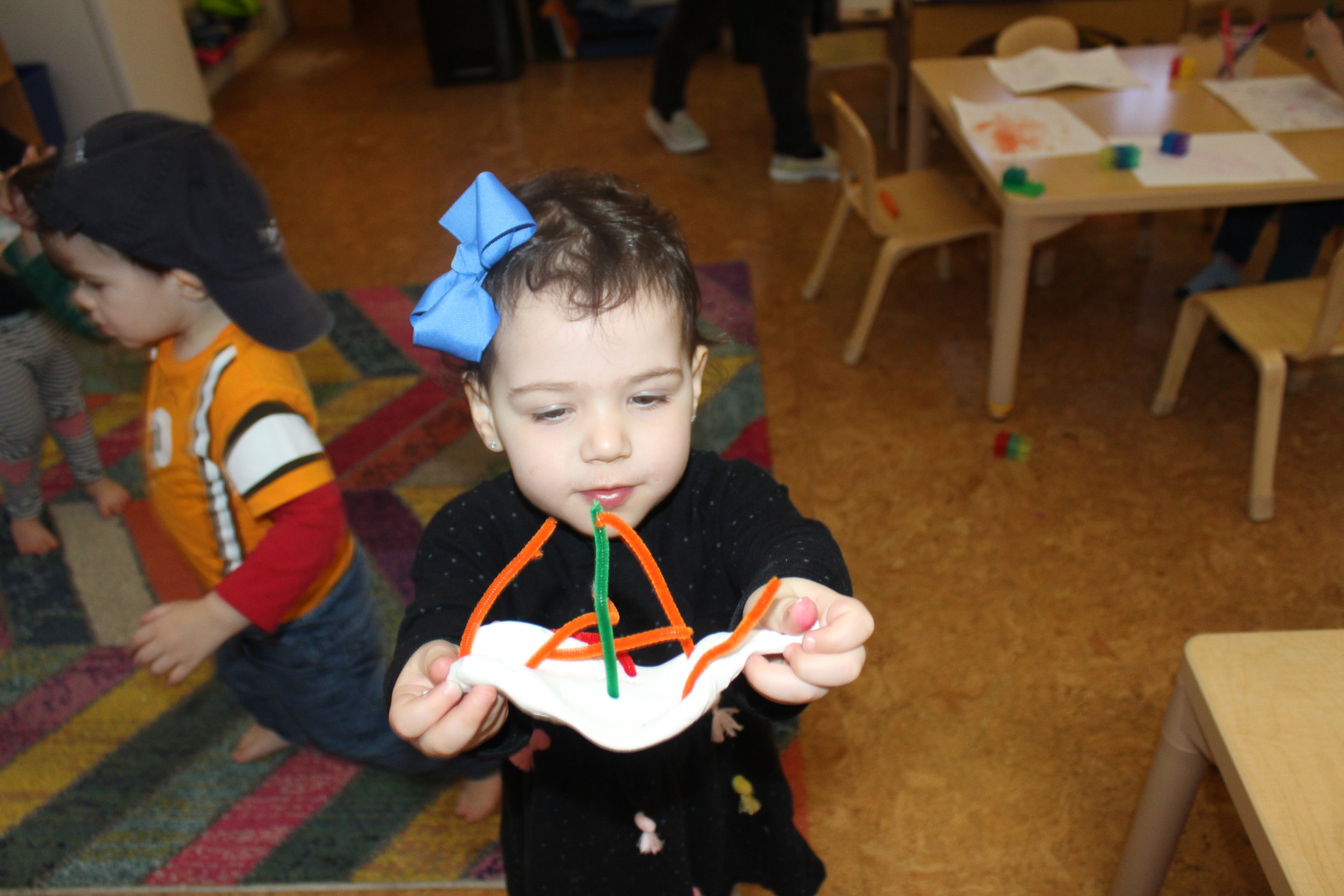  After manipulating the model magic, pressing, squeezing, and patting it, she created a structure.&nbsp; She articulated, "A boat!" 