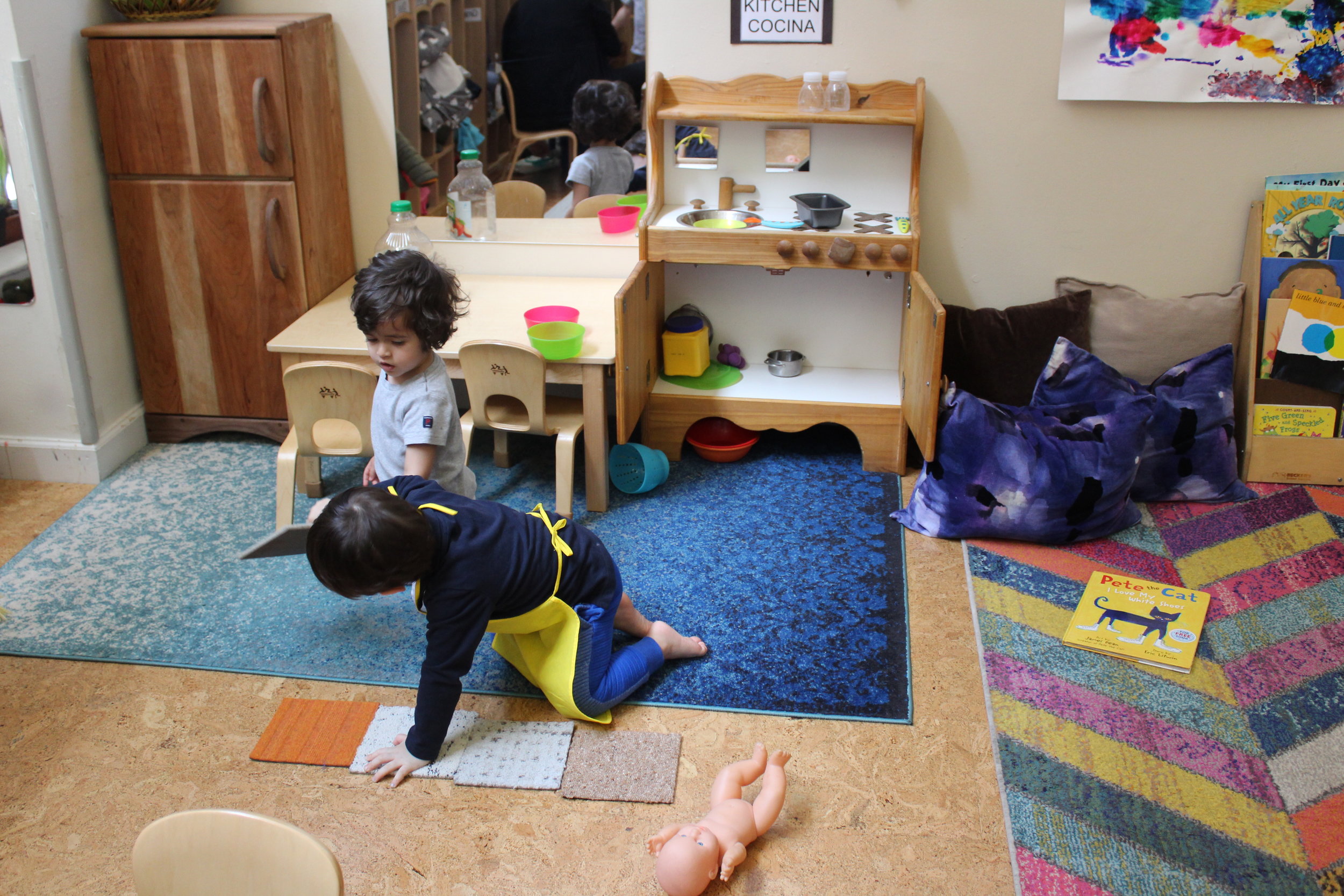  Ellie gives Mario one square carpet at a time, and Mario aligns them.&nbsp; As they play cooperatively, Mario appeared excited to have placed them together.&nbsp;&nbsp; 