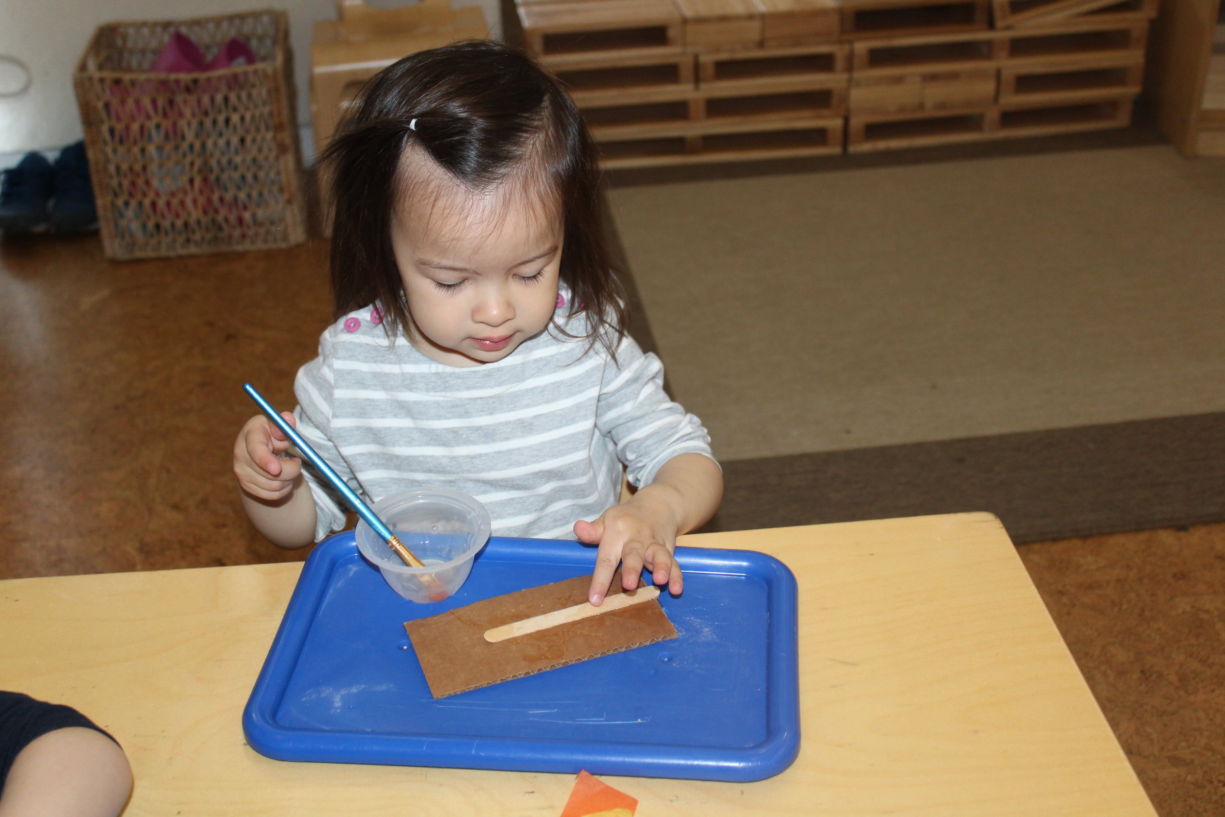  A sense of curiosity and interest stimulates young toddlers to engage with different materials. Engaging with real glue provide students to learn and explore in ways that they cannot with a glue stick. Toddlers are learning about the properties of g