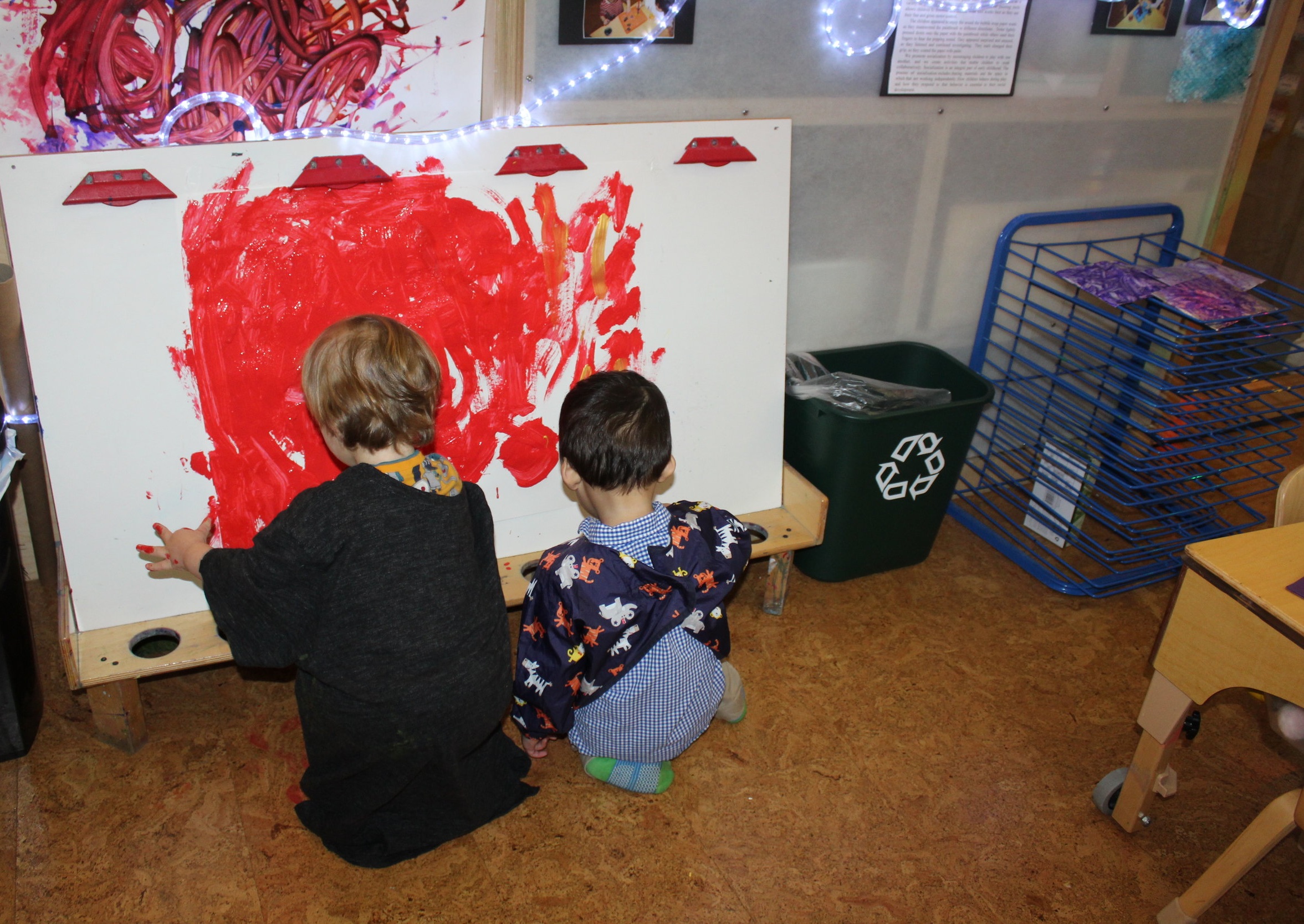  A painting experience stimulates children's brain, as they freely express themselves and develop their creativity. As he painted at the easel, Charles managed to spread the red hue across the paper. Everything he saw white, Charles covered it with p