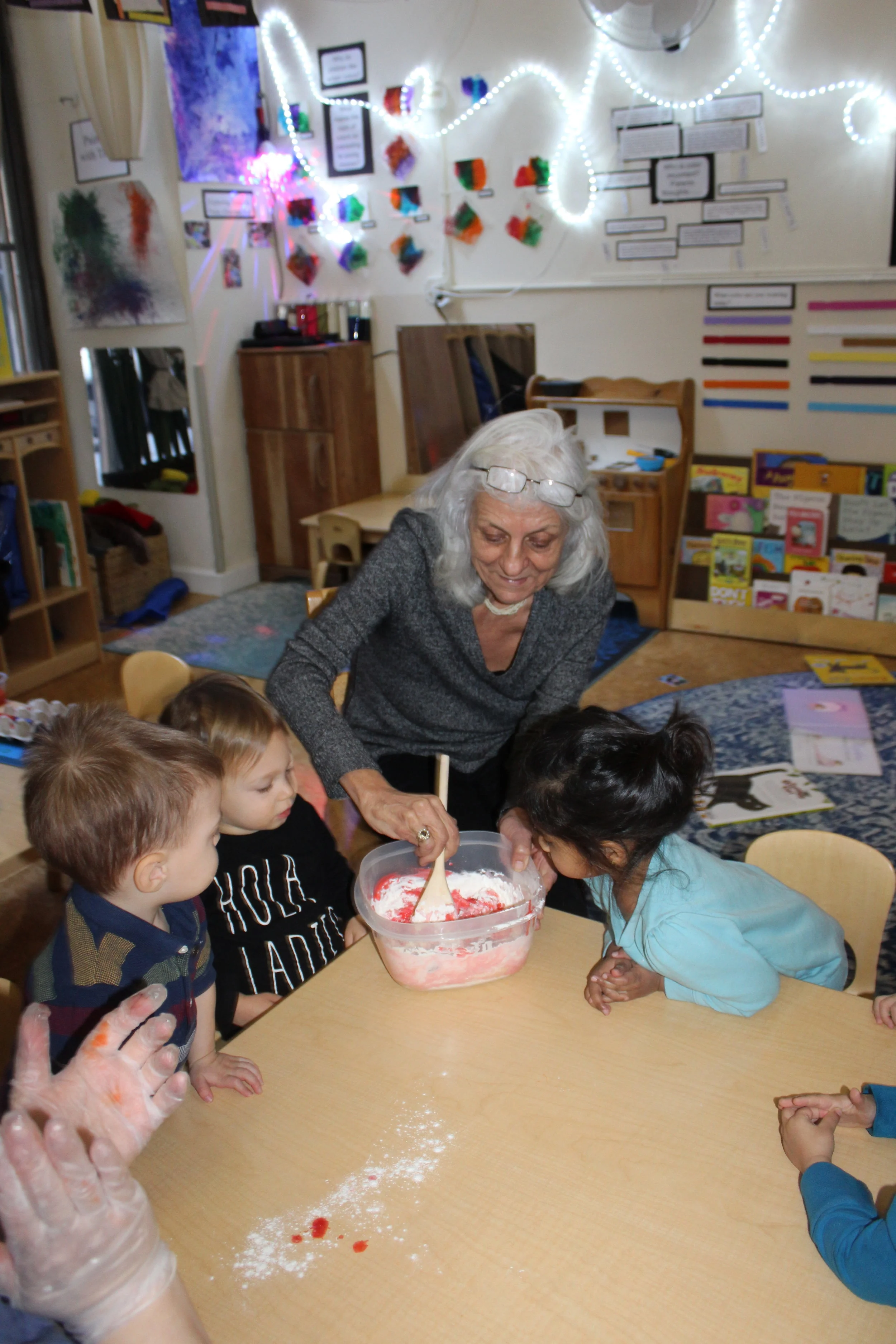  Oliver's grandmother was able to stay with us a little longer after she read a book to the children. She helped mix the flour, oil, and water to make play dough! 