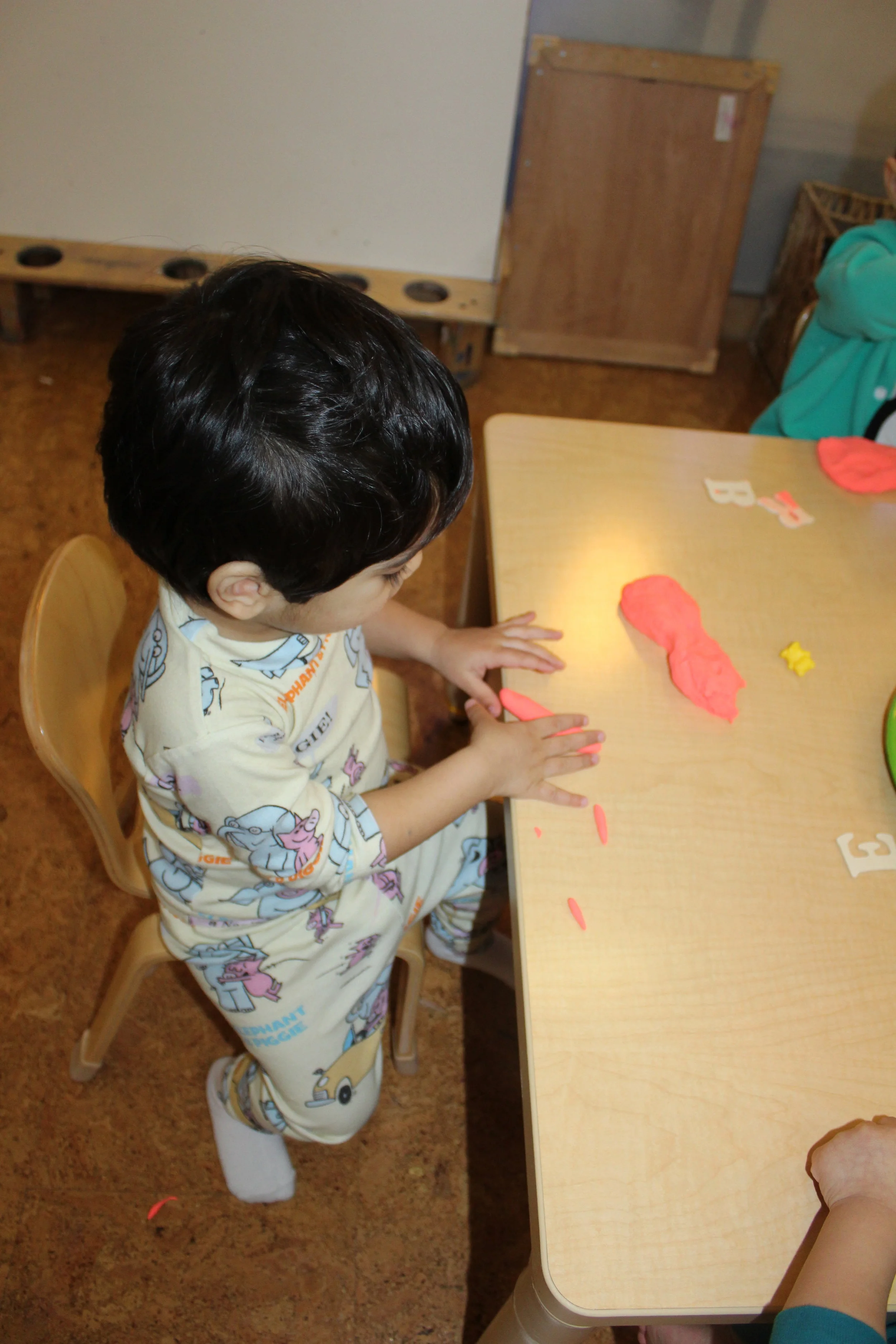  Rohan took a piece of clay and rolled it back and forth creating coils. Using his hands and fingers in a back and forth motion, he created the coil thickness.&nbsp;&nbsp;   