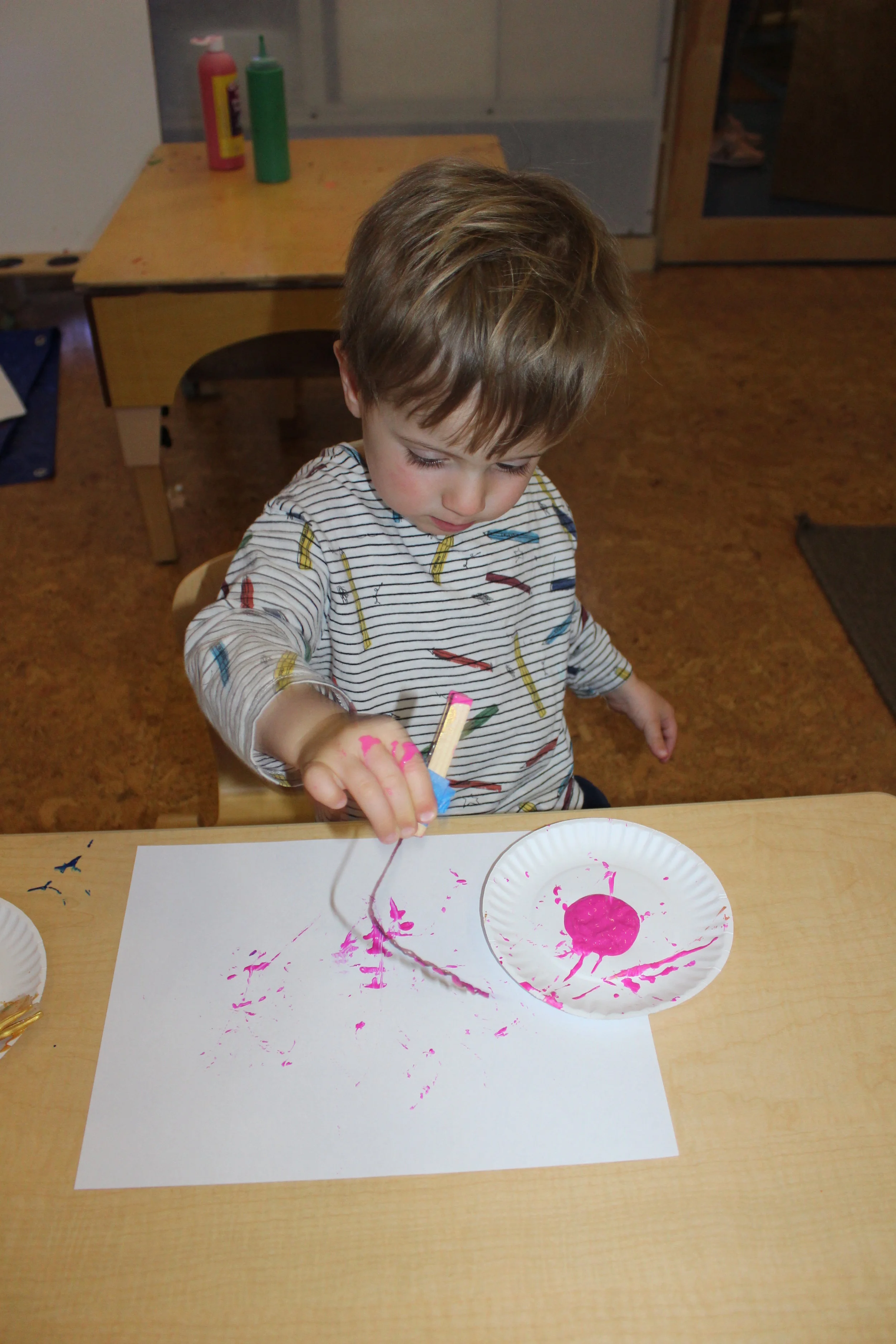  Painting with Strings using Clothespins :  The children used clothespins to hold the string and dip the string into the paint and onto the paper. As they select their colors and distinctive movements, they create their design. 