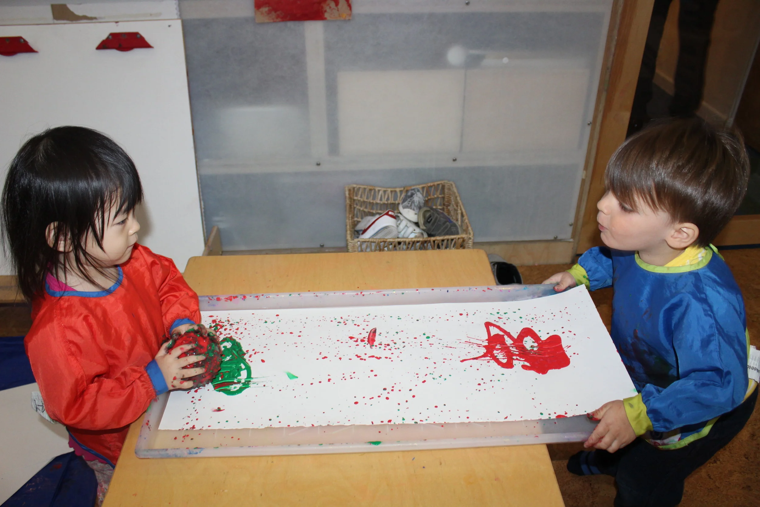   Revisiting Ball Painting:  The art activity involved the upper body as the children focus on rolling and pushing the sensory ball with their hands. They each selected the colors, and as they moved the ball back and forth, the ball left a trail of p