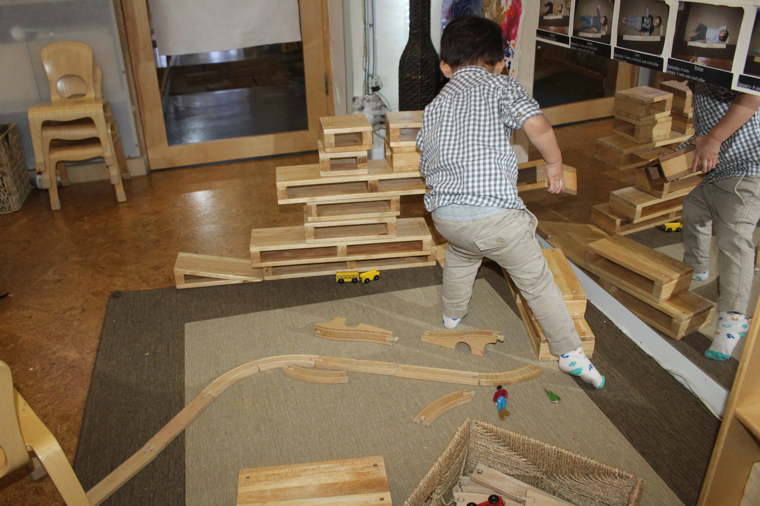  Cooper has been discovering how different blocks feel in his hands, and about space and shapes. He develops ideas and interests of his own as he selects the blocks he wants to use. Cooper did not express what his structure was about but continued pu