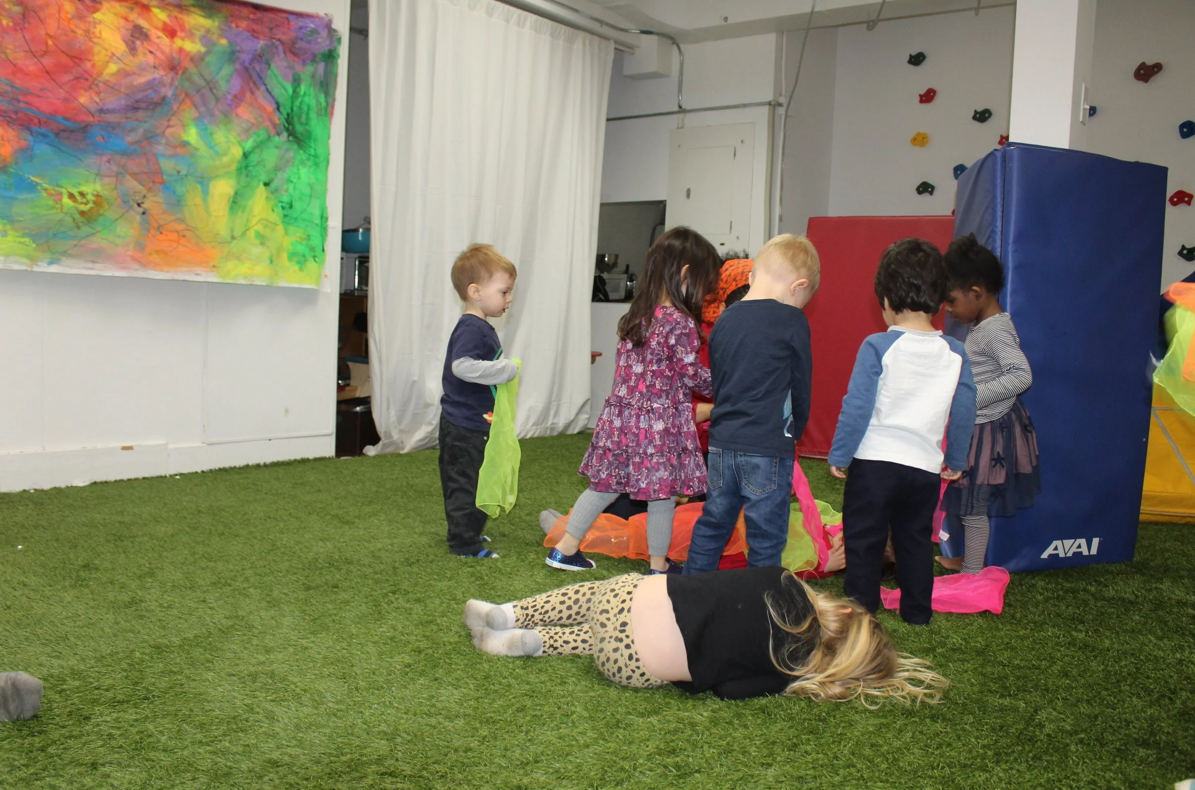  The specialist explores the sensory scarfs with the children. They are great sensory props to lay over the face; they see the world in a different color or blow with all their might to see the scarf fly up into the air. The children seem to enjoy wh