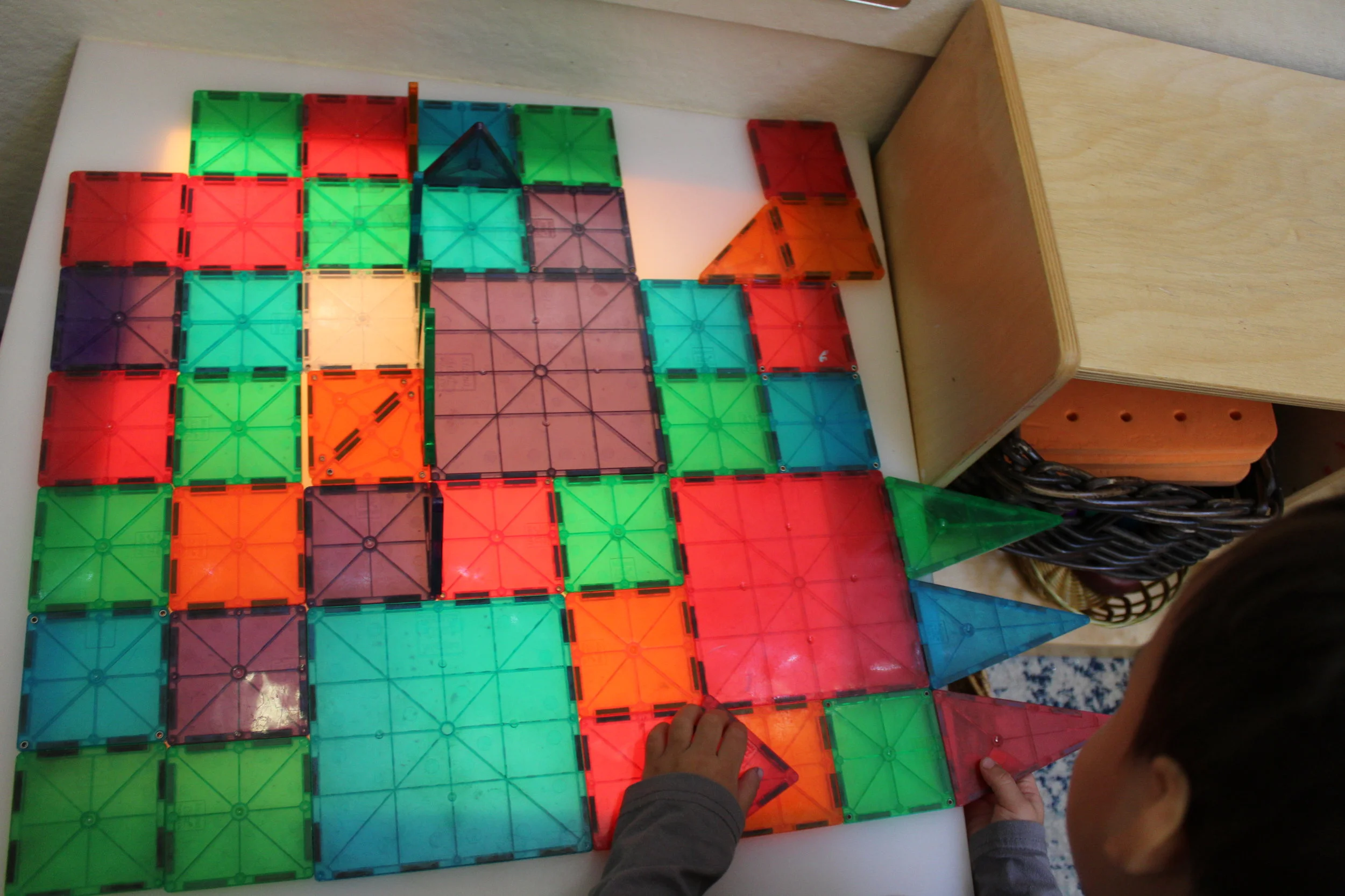   As Cooper interacted with the Magna-tiles, he arranged the big and small squares on different areas of the light table. Amazing!! He described his structure, "A octopus!" 