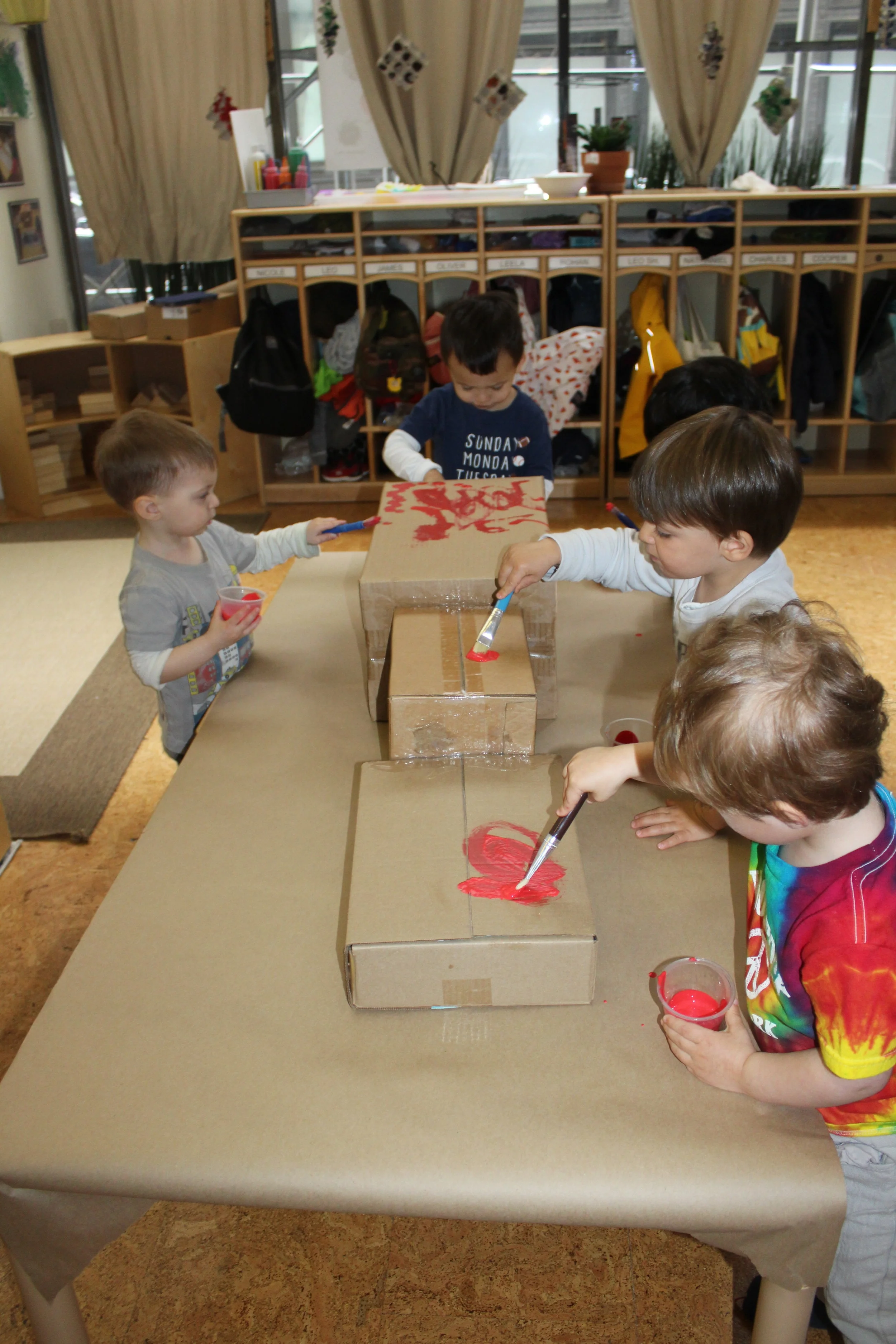 Collaborative Painting&nbsp;  All the children are participating in painting their train.&nbsp; They selected the color red, and it's going to be called the A train! 
