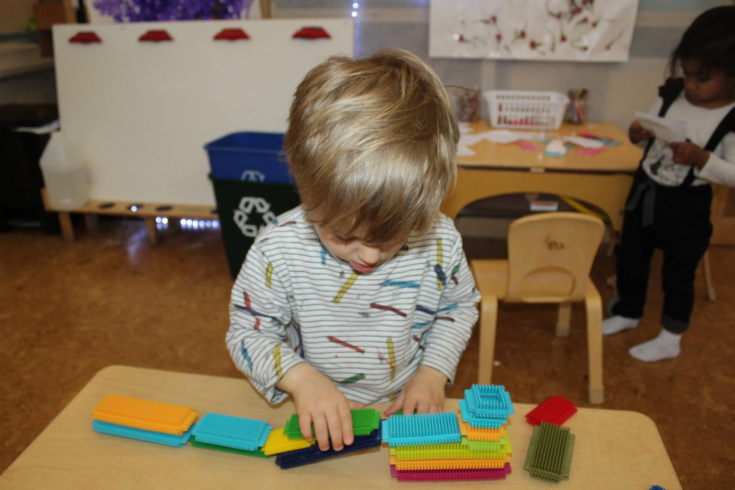  What are you building with the Bristle Blocks, Leo? "Building a train!"  Who is on the train? “Mom, dad and me going to the beach. Get a crab, turtle, and shells.” 