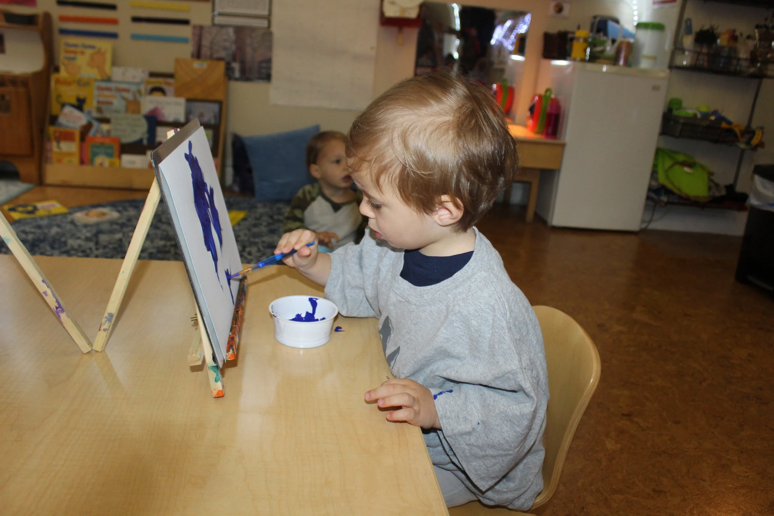  The children have always enjoyed painting on the small tabletop easel.&nbsp; &nbsp;It gives them a different perspective on painting; for example, arm and hand movement.&nbsp; Charles appears focus as he paints and adds details to his paintings.&nbs