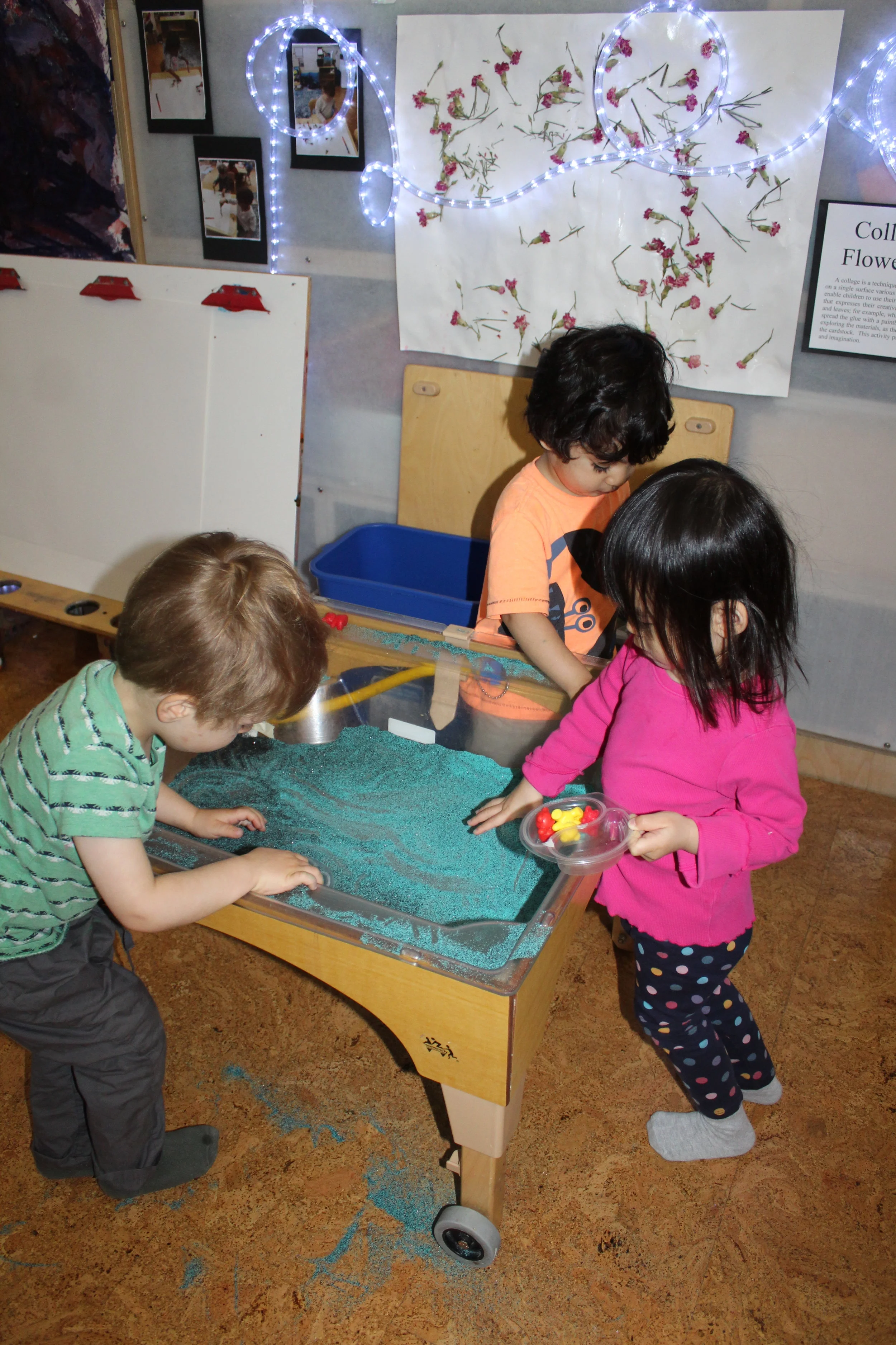  The children touched scooped and filled small cups with colored sand.&nbsp;   