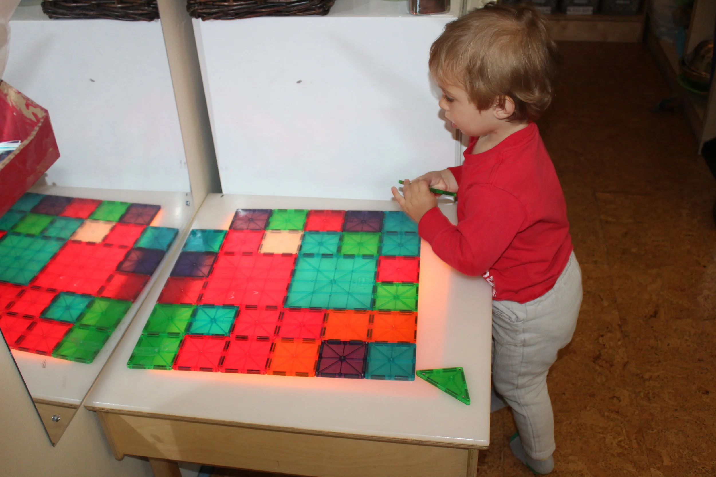  Charles demonstrated focus and concentration as he connected the different color squares. Even though they were all the same geometric shape, Charles carefully observed, selected, and arranged the color squares.     