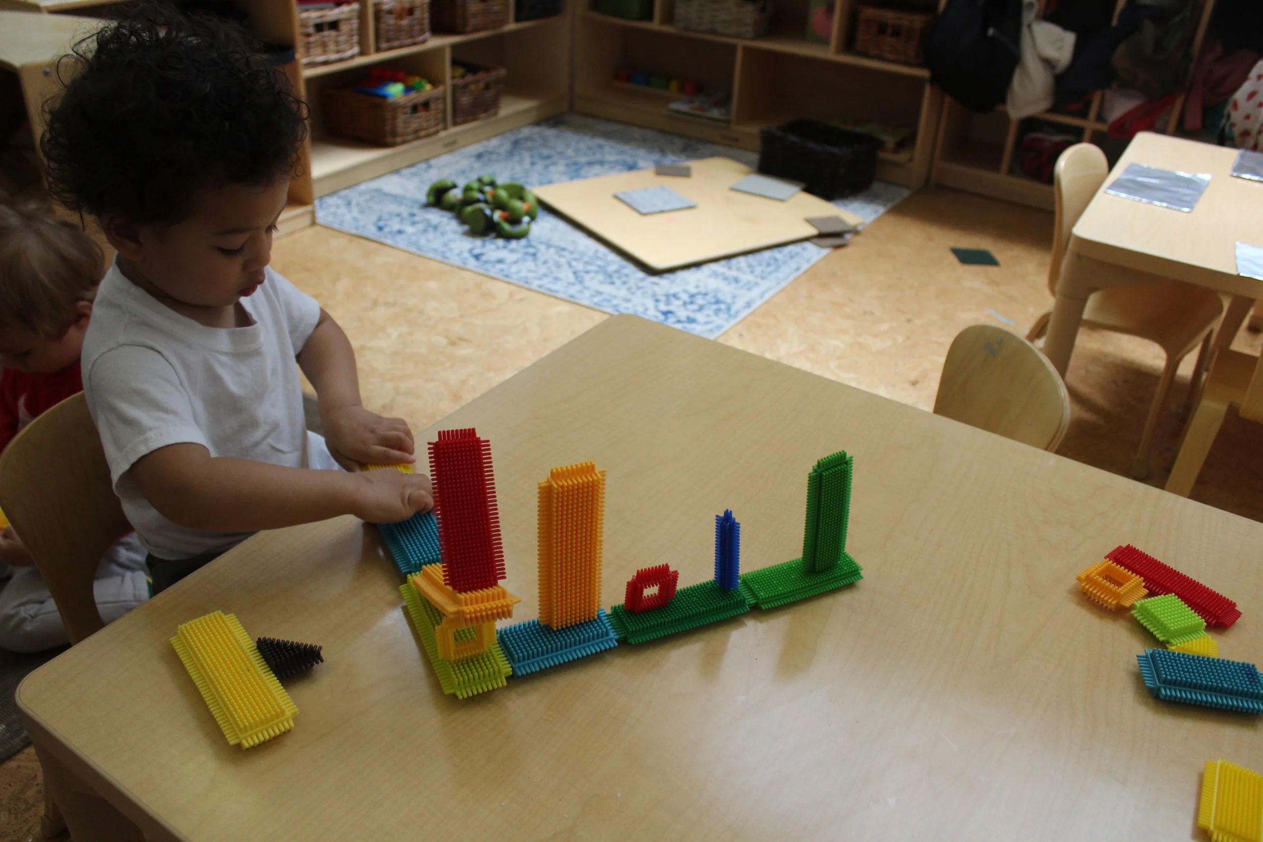   Teacher : “Nate, I like the way you are connecting the Bristle Blocks.  What are you building?”   Nate :”A train.  Dad’s in the train.  I’m in the train, too!”   Teacher : “Where are you going?”   Nate : “I’m going to Penn Station!”  Manipulative a