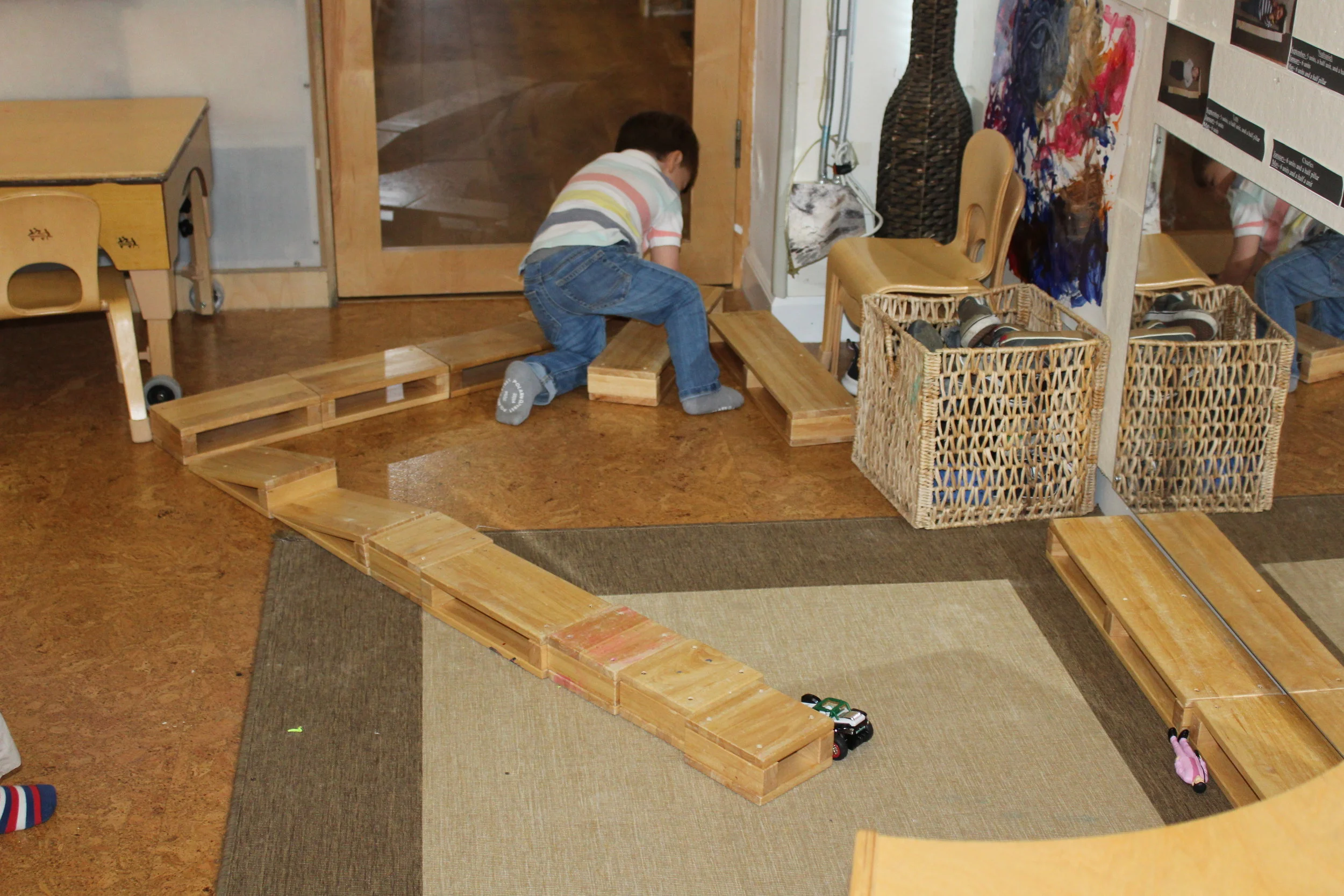  The hollow blocks are being used frequently by the children. As they construct, they are creating different configurations. James is building a road.&nbsp; &nbsp;&nbsp;Large muscles and imaginations are hard at work when the children build with thes