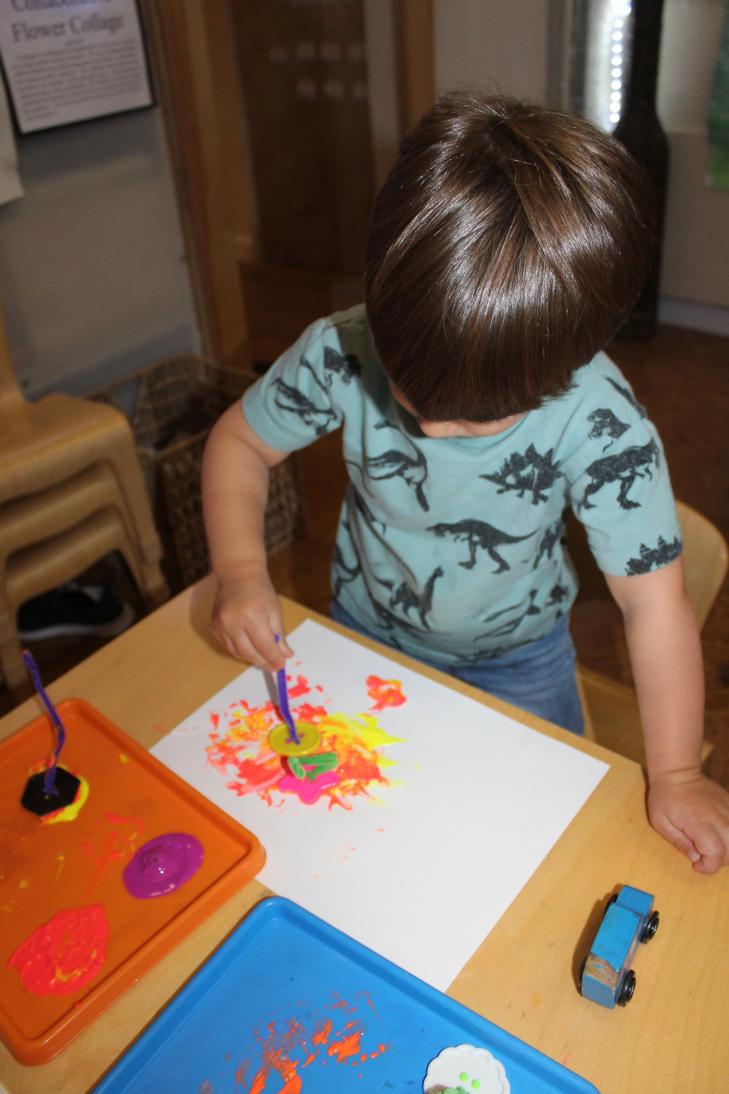   We want children to explore and be creative as they investigate.   As teachers, we always like to create different drawing tools.   The children seemed curious as they dipped the button into the paint and onto the paper.   