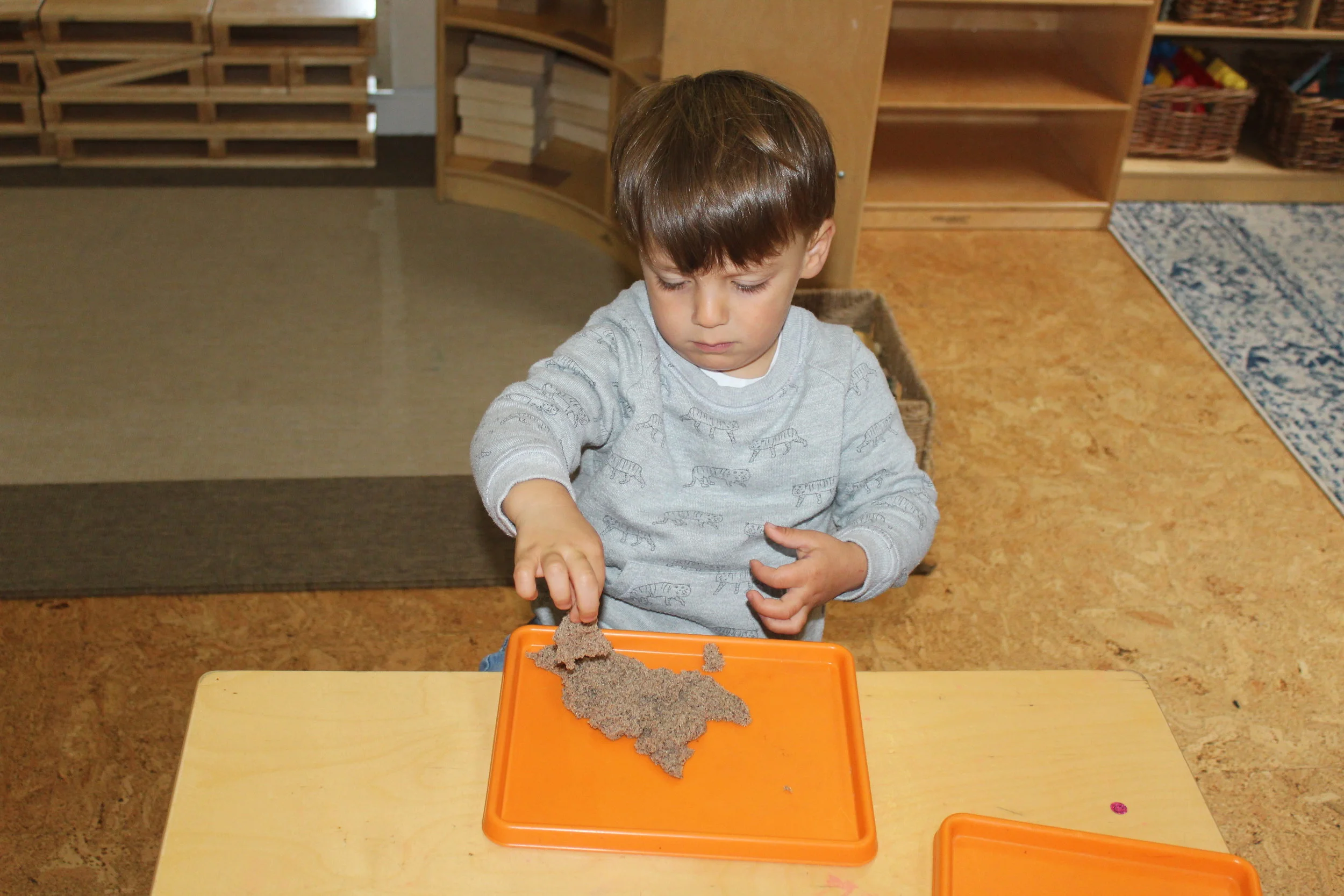 The children were exploring and discovering Kinetic sand.
