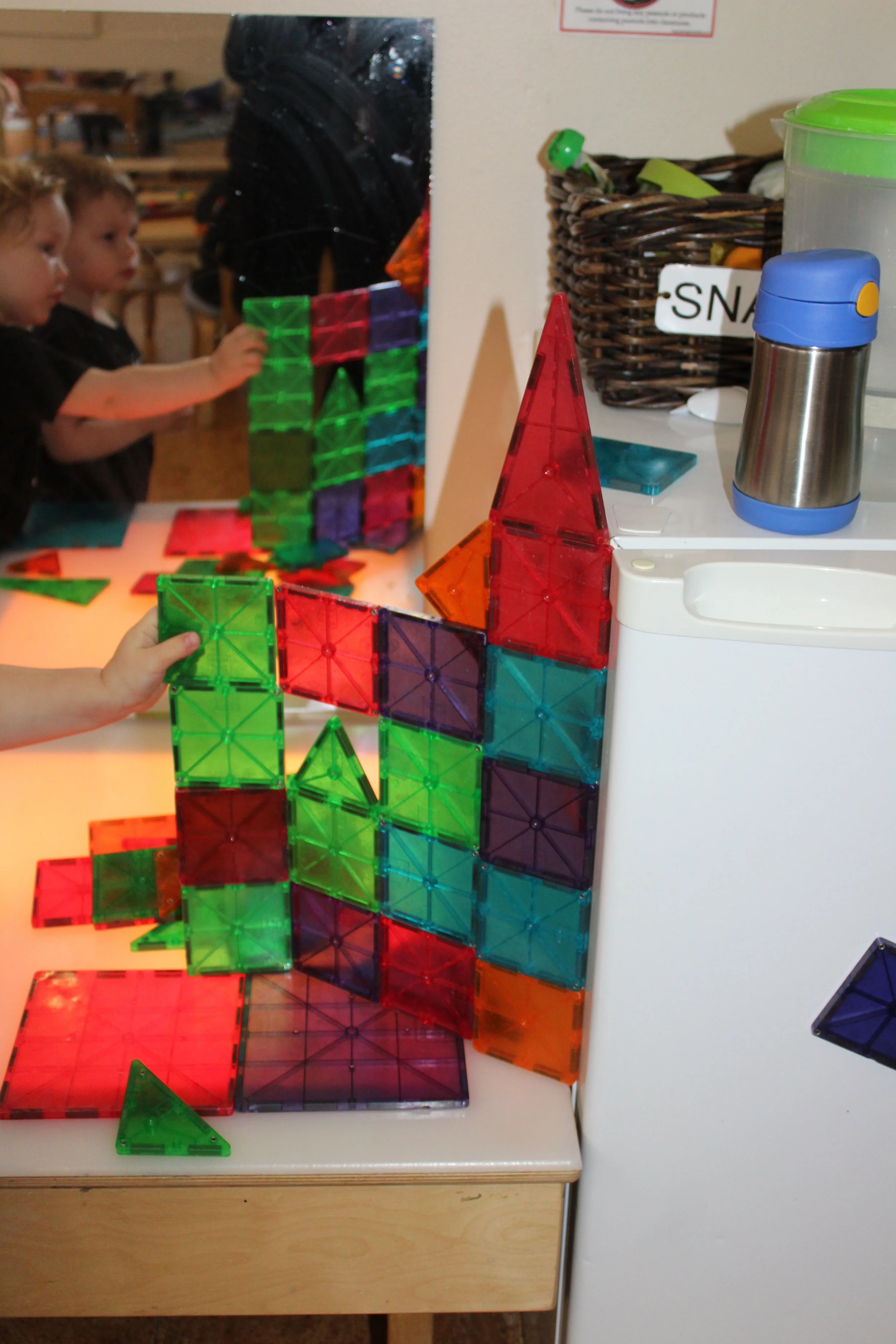 Leo and Nate created a wall of Magna-tile, and then Alex joined them.