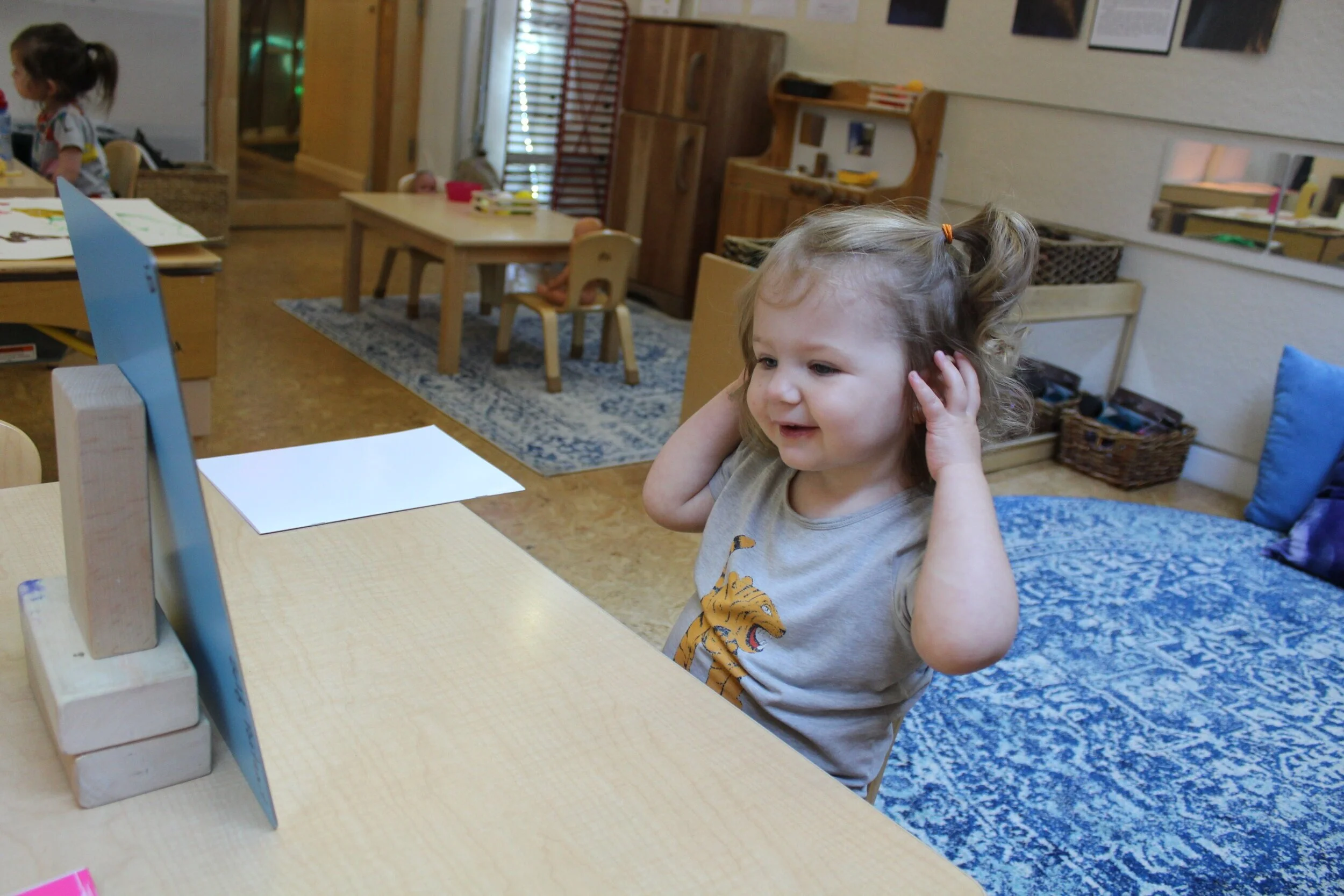  Ophelia pointed to her nose, ears, and mouth. 