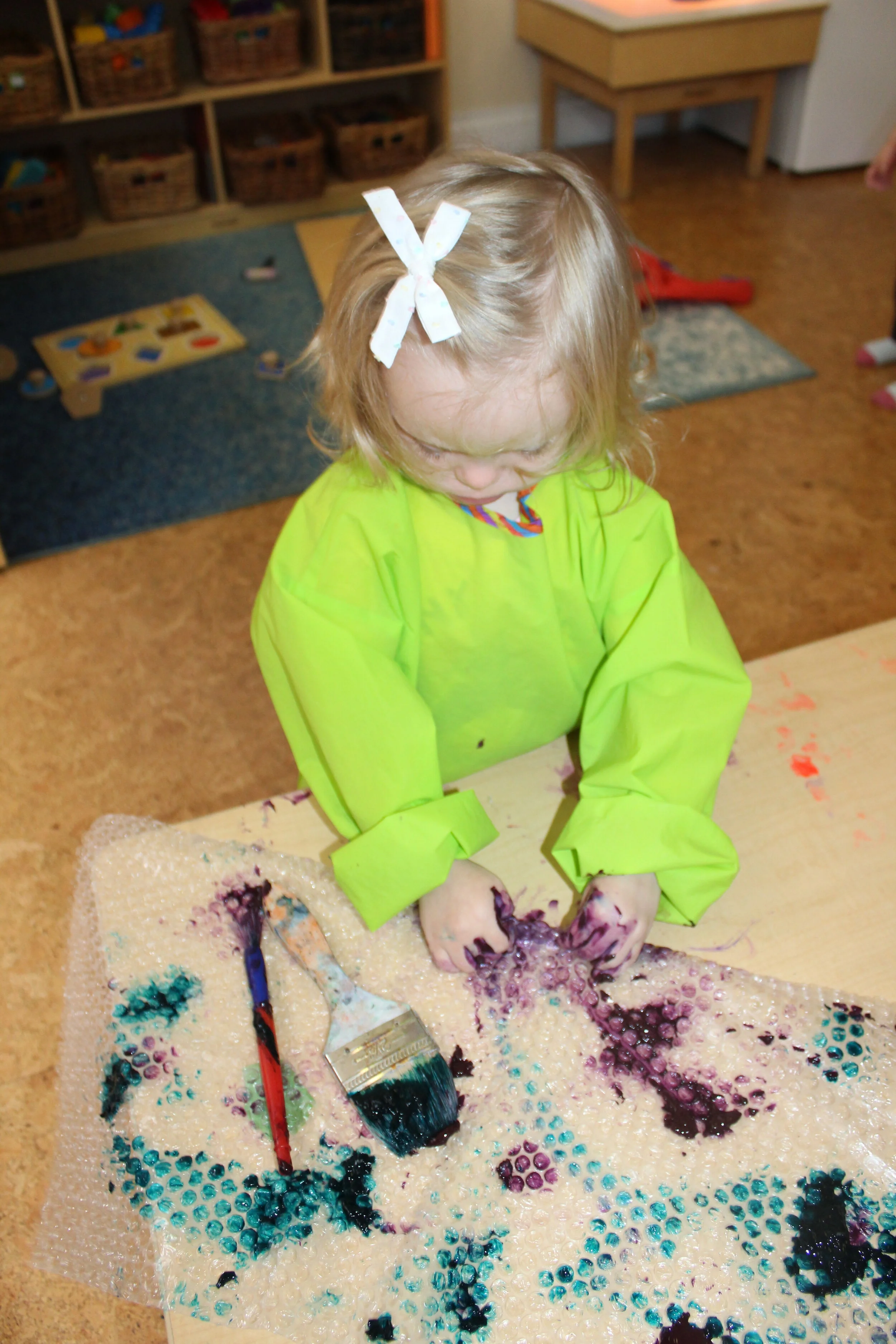  The children pressed the paper and gradually increased their speed, as they hear a popping sound.  They changed the grip, as they alternated tools and lightly touched and pressed down onto the paper with their fingers and popped! The children appear