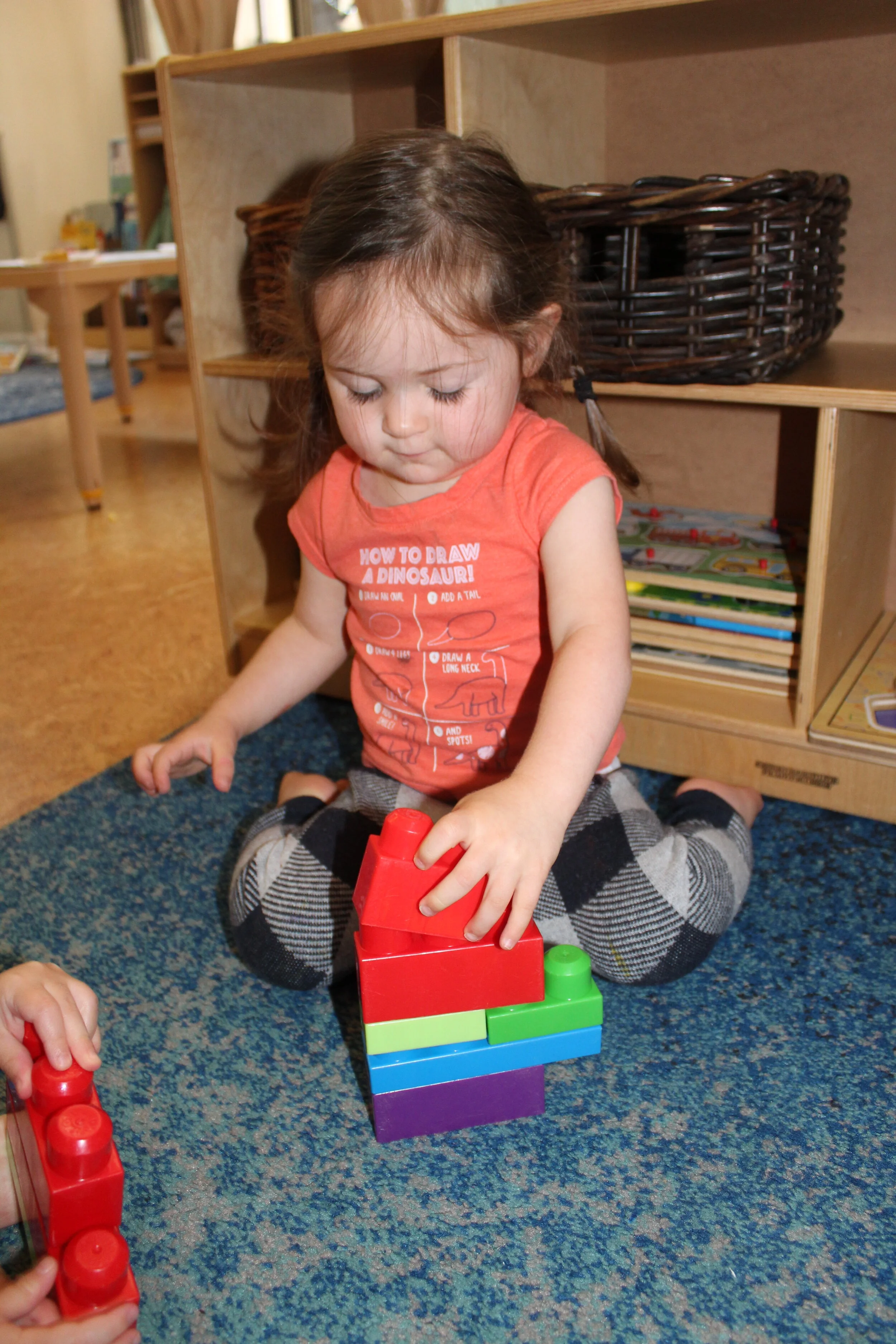   Annabelle:  “I made my tower!”   Teacher:  “Who lives in your tower?”   Annabelle:  “Papa, mama, and grandpa!”   Teacher:  “What are papa, mama, and grandpa doing?”   Annabelle:  “Mama driving a car!   (Suddenly she said)   Look at the picture Sand