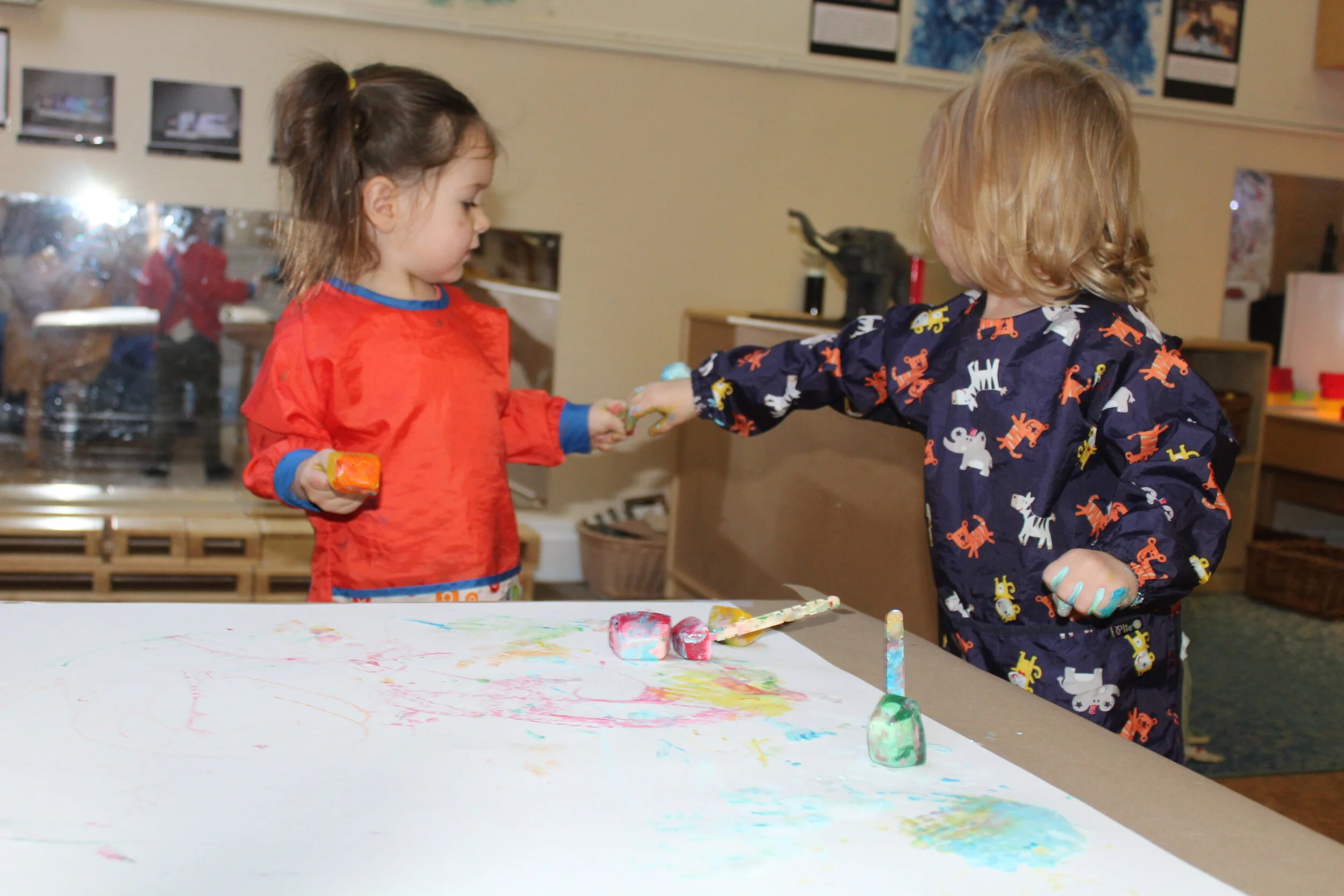  Collaborative painting promotes sharing and socialization.   Teagan  shared the ice Popsicle stick with Annabelle after she was all done. 