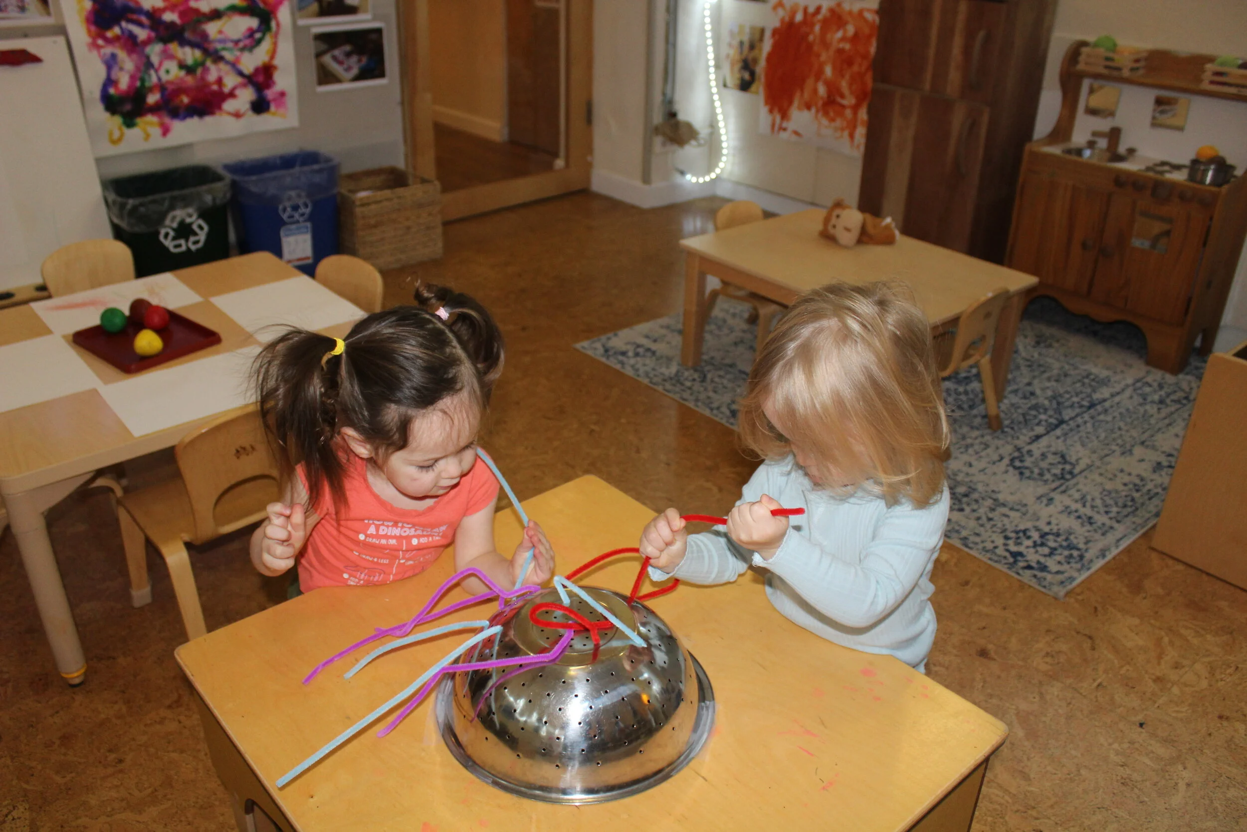  The colander and pipe cleaners activity always interests the children. It is challenging as they need to focus on inserting the pipe cleaners in the holes. As they interact, they are entirely focused and determined to fill all the holes in the colan