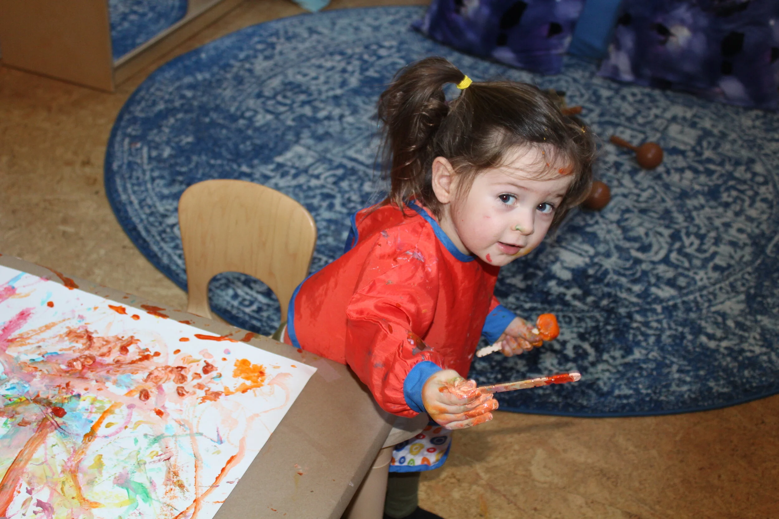  Annabelle is all done painting and gives the teacher the popsicle sticks, “Can you take care of this!”   