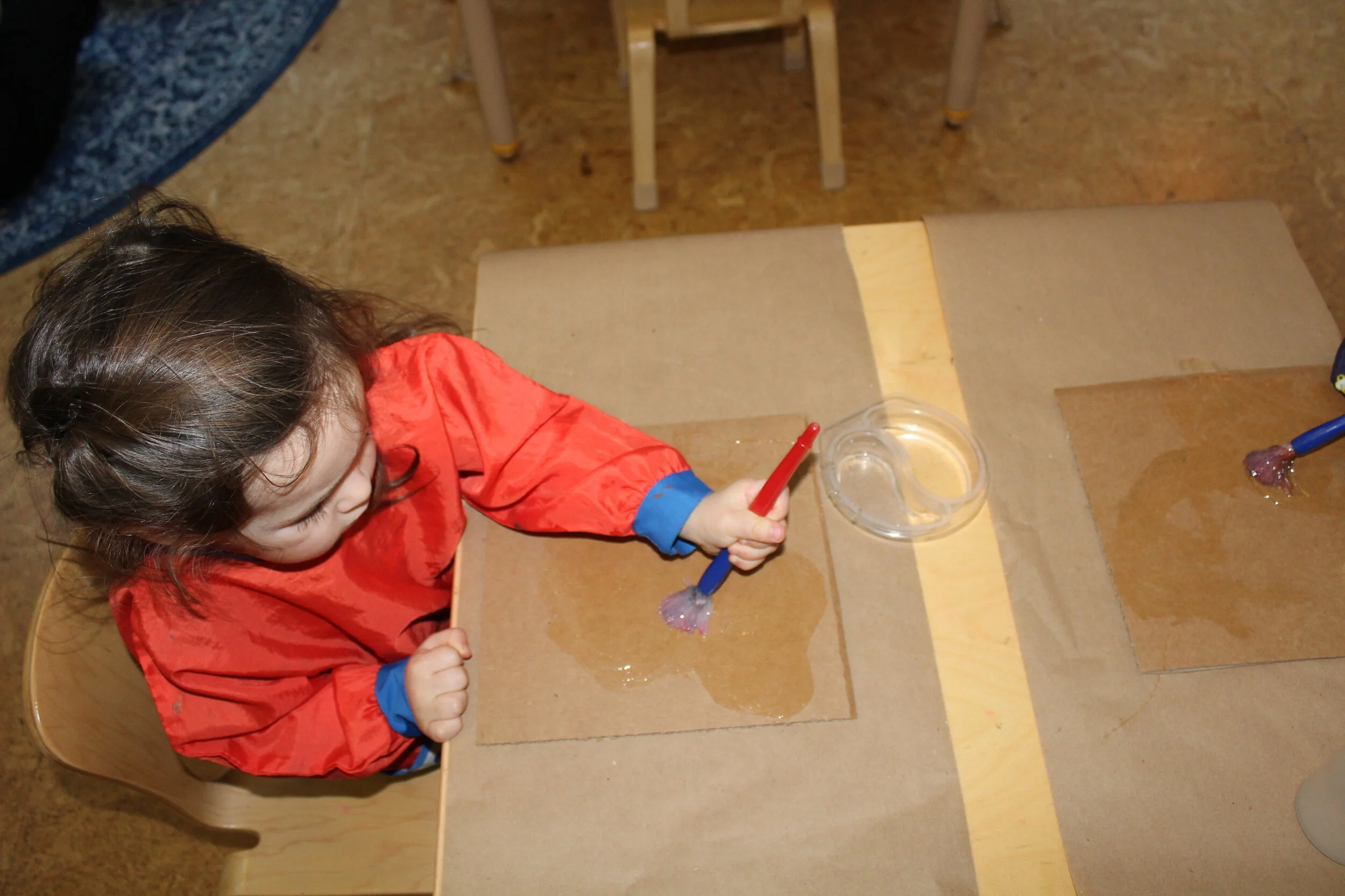  The children created a leaf collage.  A collage is a technique of composing a work of art by pasting on a single surface various materials.  We collected some leaves and small tree branches for our natural collage.  The children squeezed some glue o