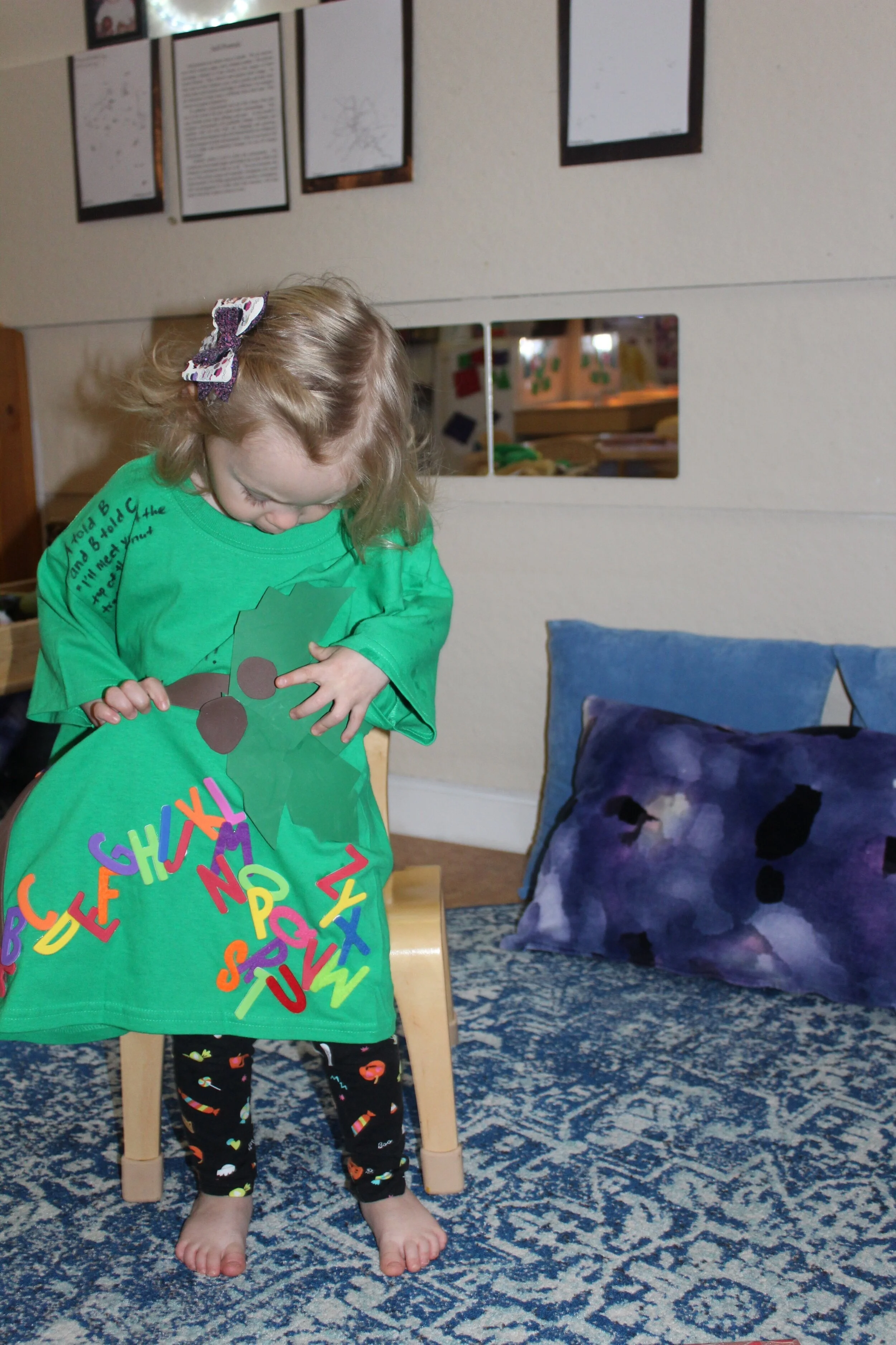  Teagan showed the teacher the letters and tree on her shirt.   Teagan : “Brown circles! Letters!" 