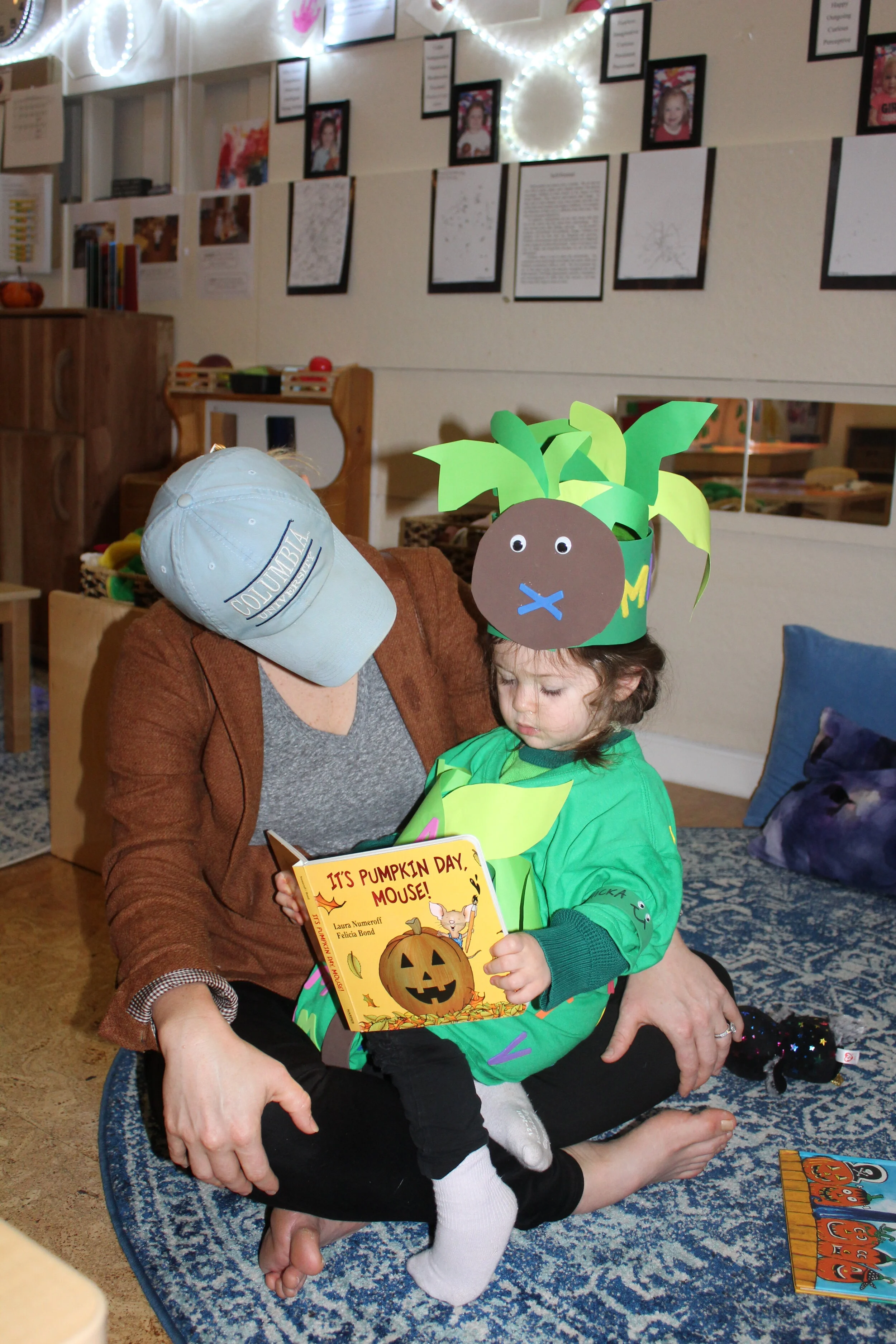  One of our Halloween traditions is to look, read, listen to Halloween books. Annabelle seems to enjoy looking at one of the books. It's  Pumpkin Day, Mouse! By  Laura Joffe Numeroff ,  with her mother, Carly. Teagan is also looking at  Aaaarrgghh! S