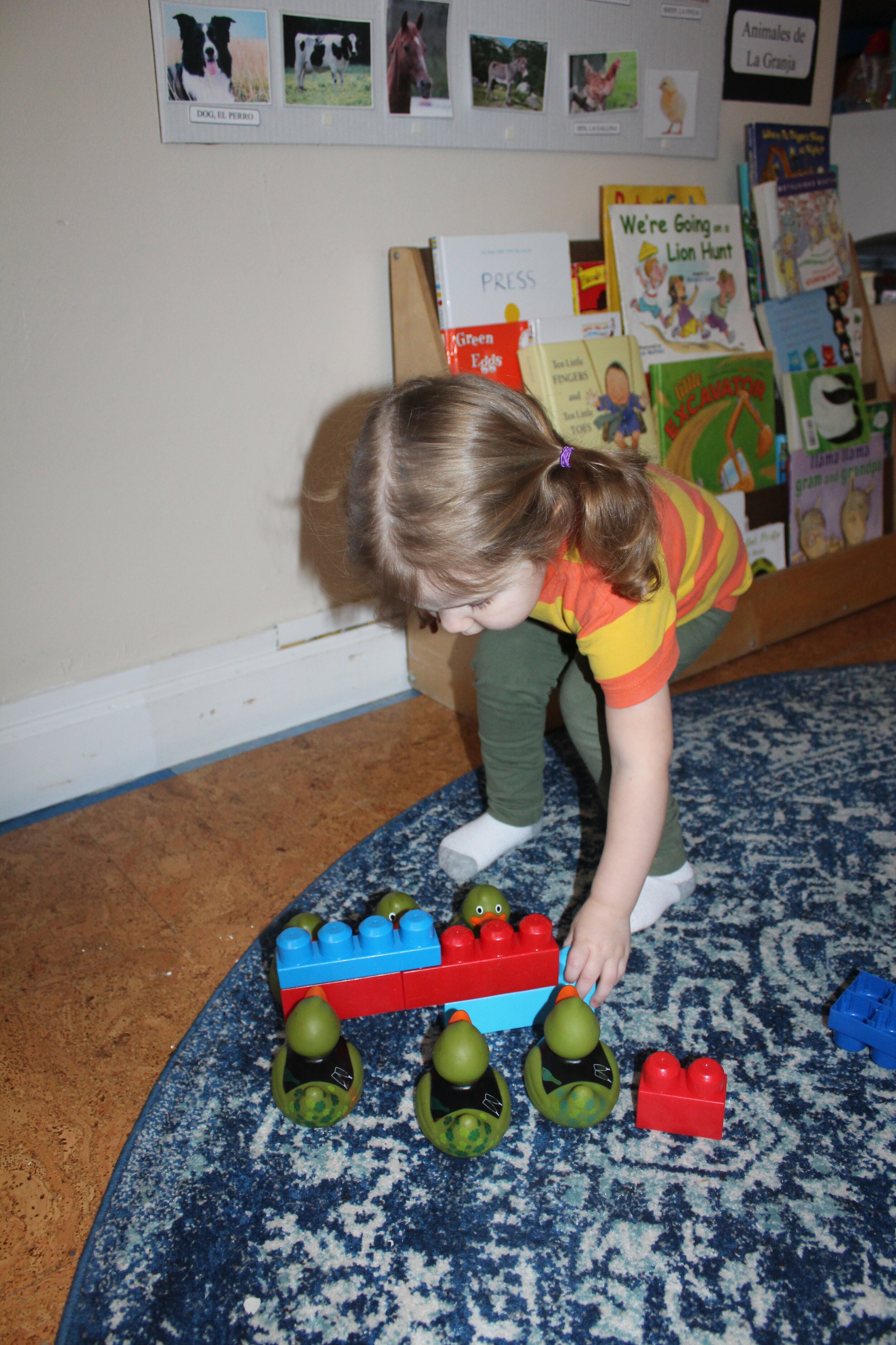  Ophelia selected and overlapped four Lego Blocks as she connected them. She articulated her structure, "Stairs!" Ophelia placed three ducks on each side and expressed, "Duck going up the stairs!" Ophelia did not articulate where the ducks were going